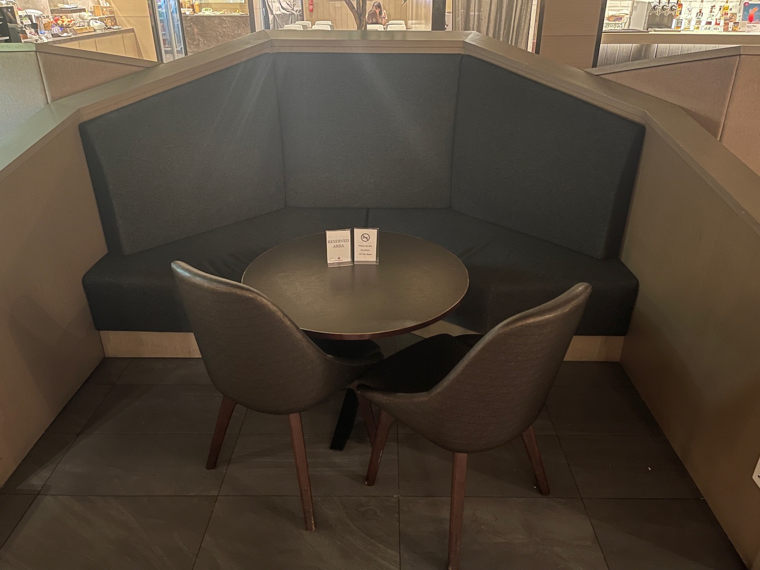 a table and chairs in a corner booth