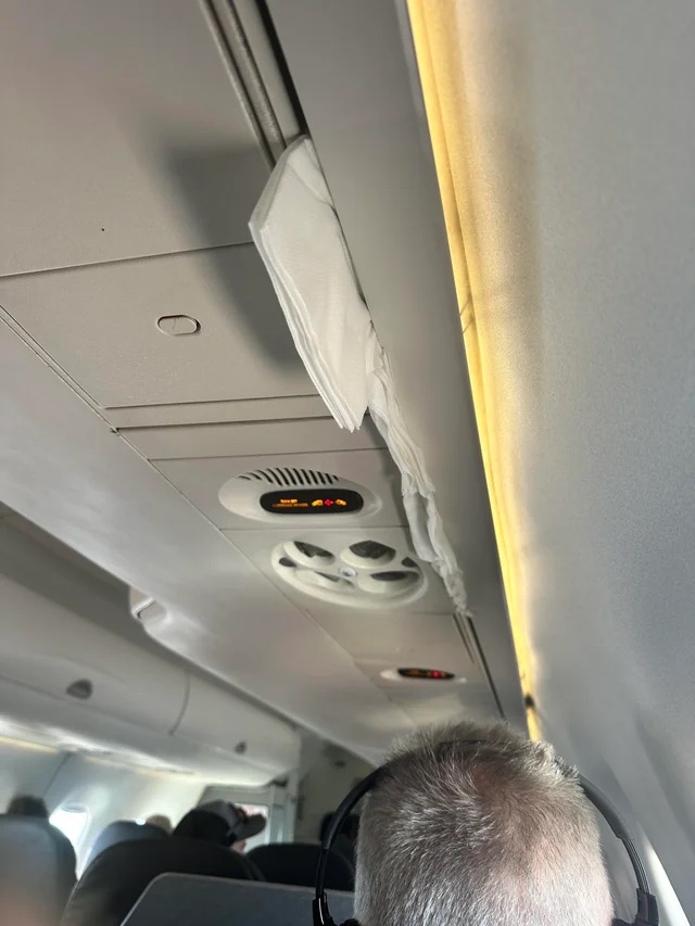 a man in headphones on an airplane