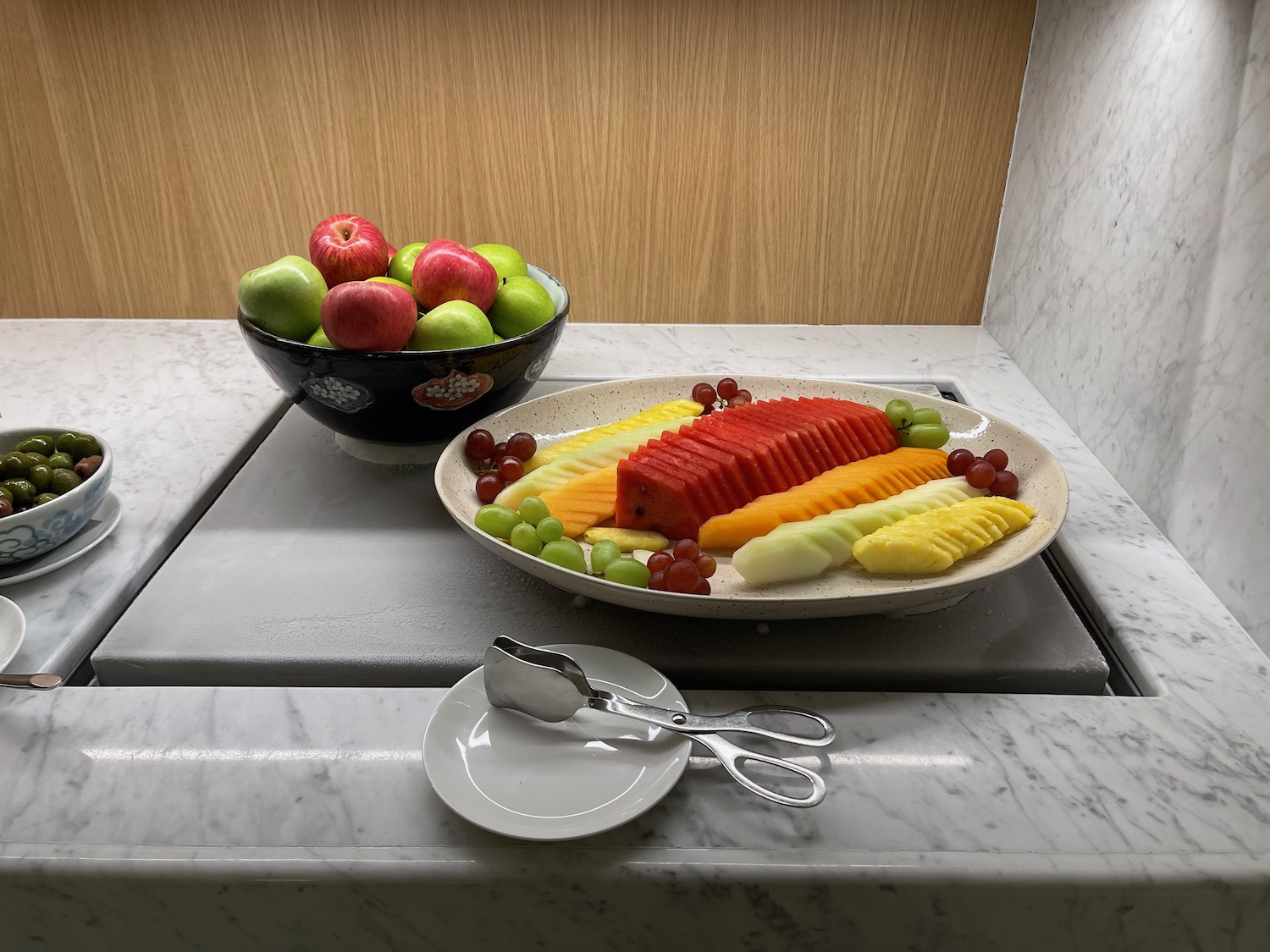 a plate of fruit and a bowl of apples
