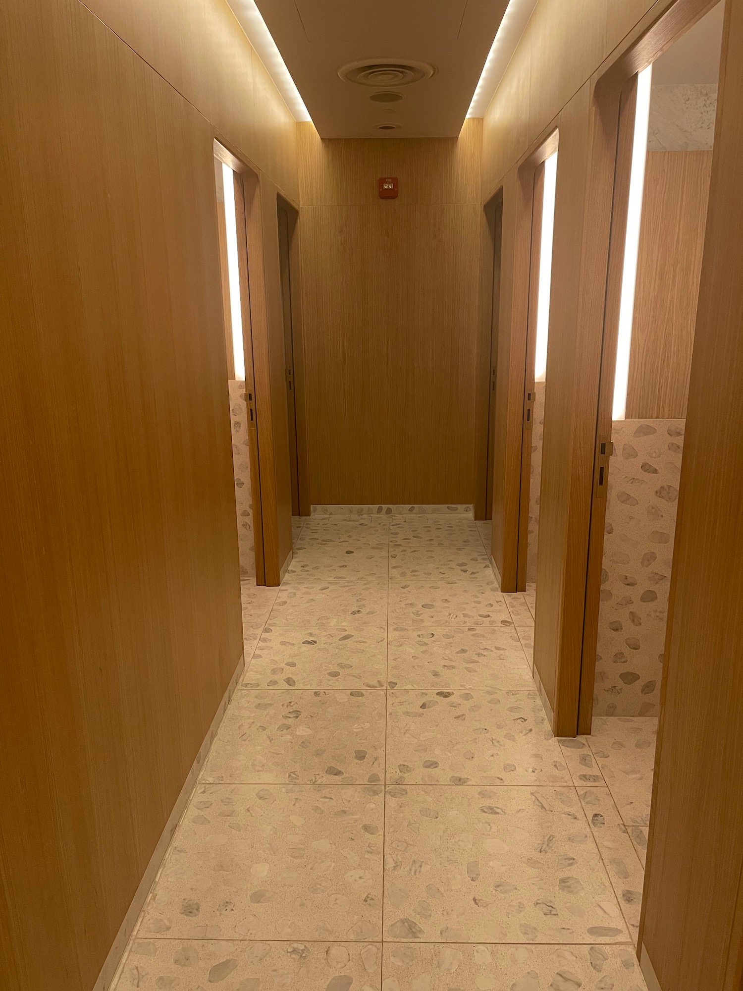 a hallway with doors and a light on the ceiling