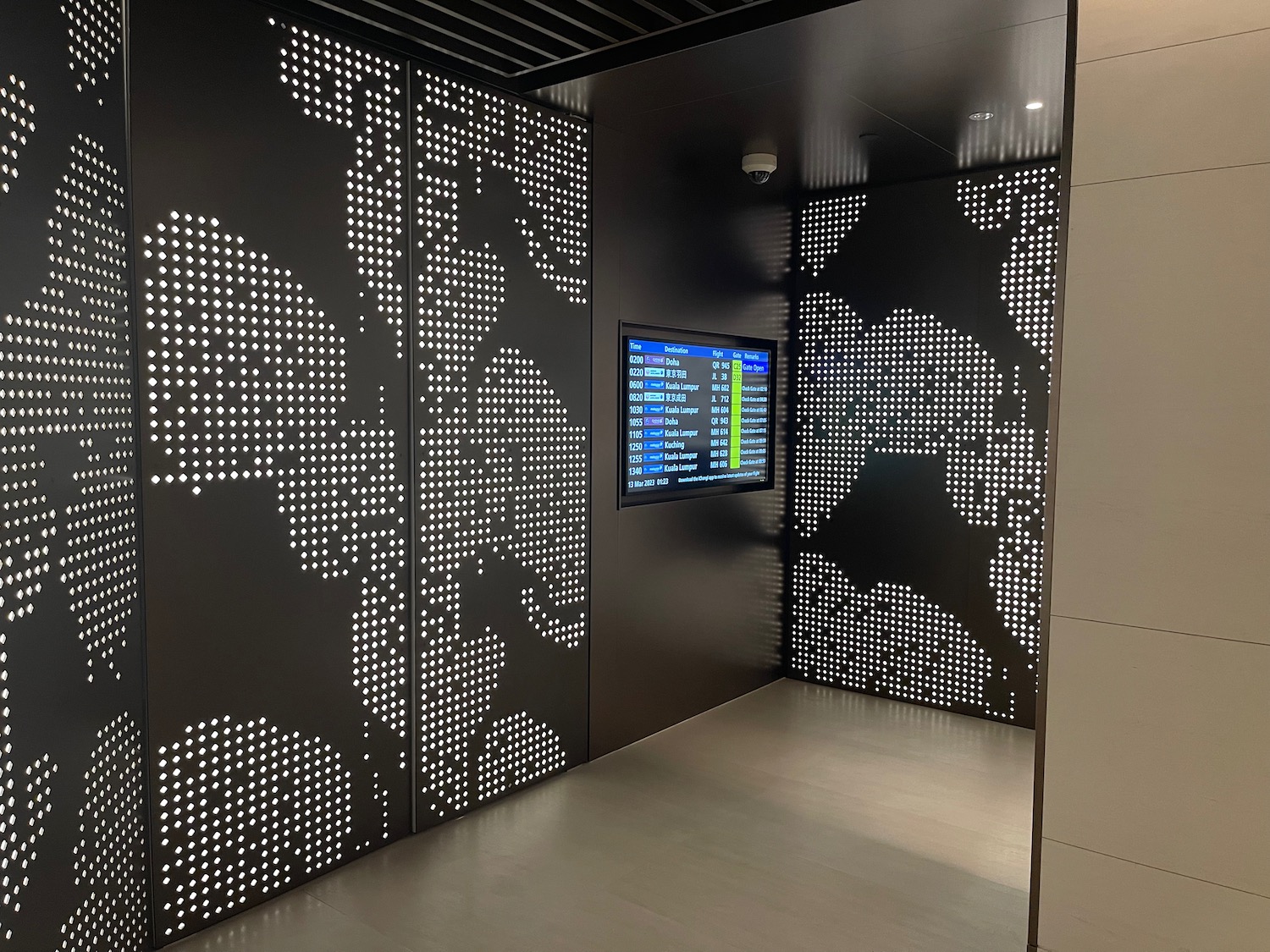 a black wall with a screen and a map of the world