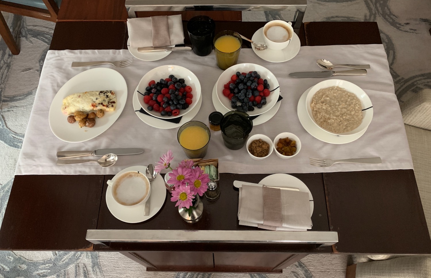 a table with plates of food and drinks