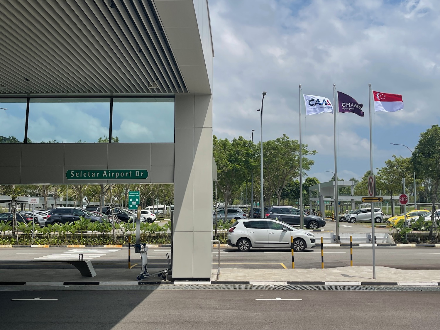 a parking lot with flags and cars
