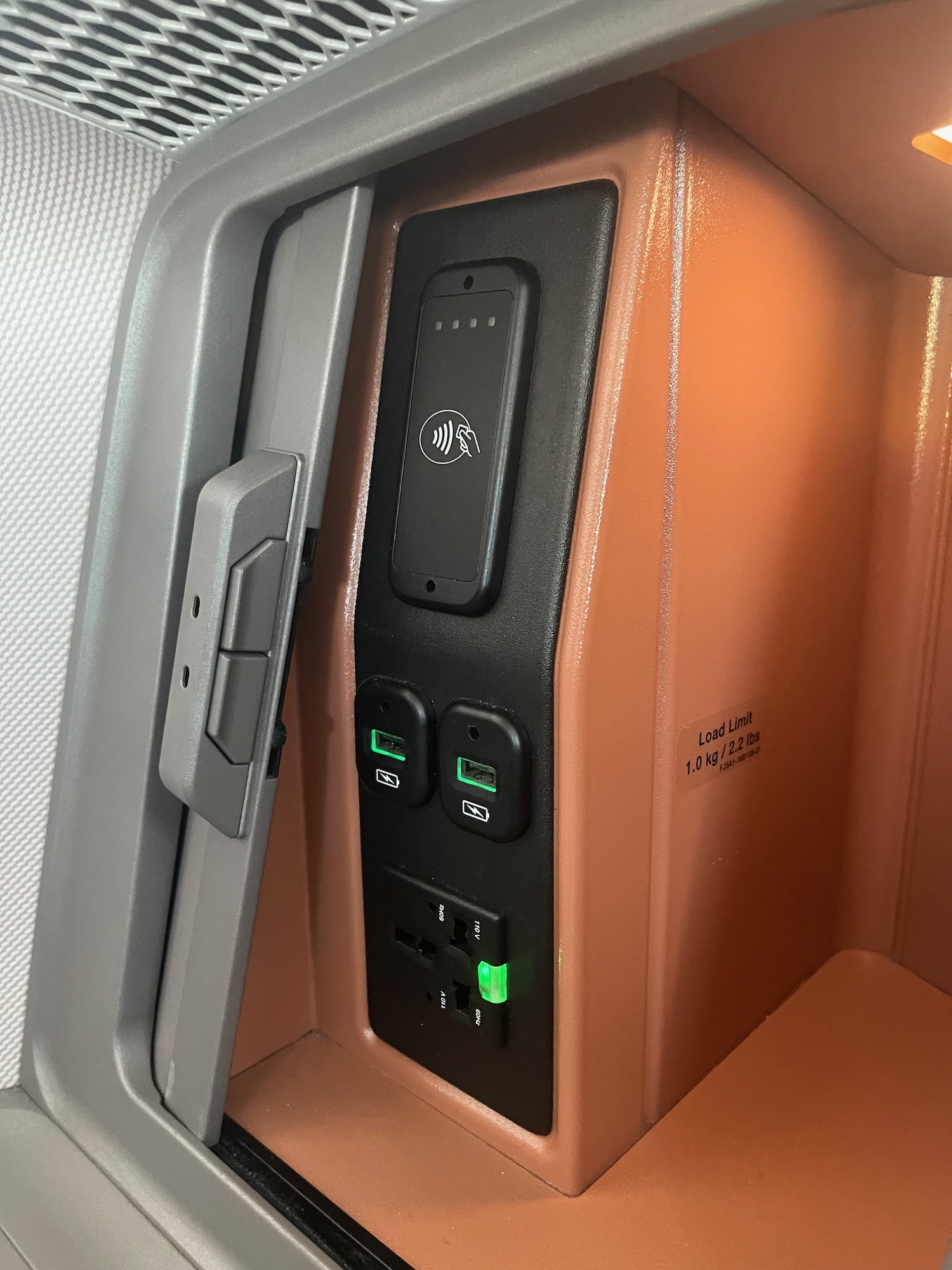 a phone charging station in an airplane