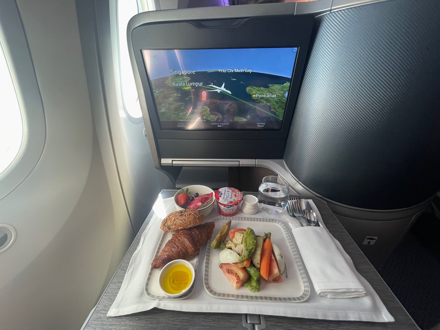 a tray of food on a table in an airplane