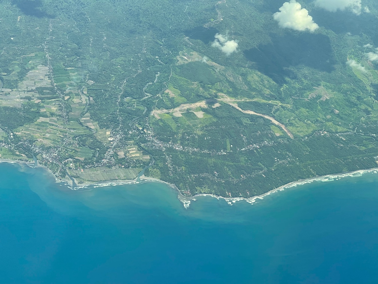 an aerial view of a land with a body of water