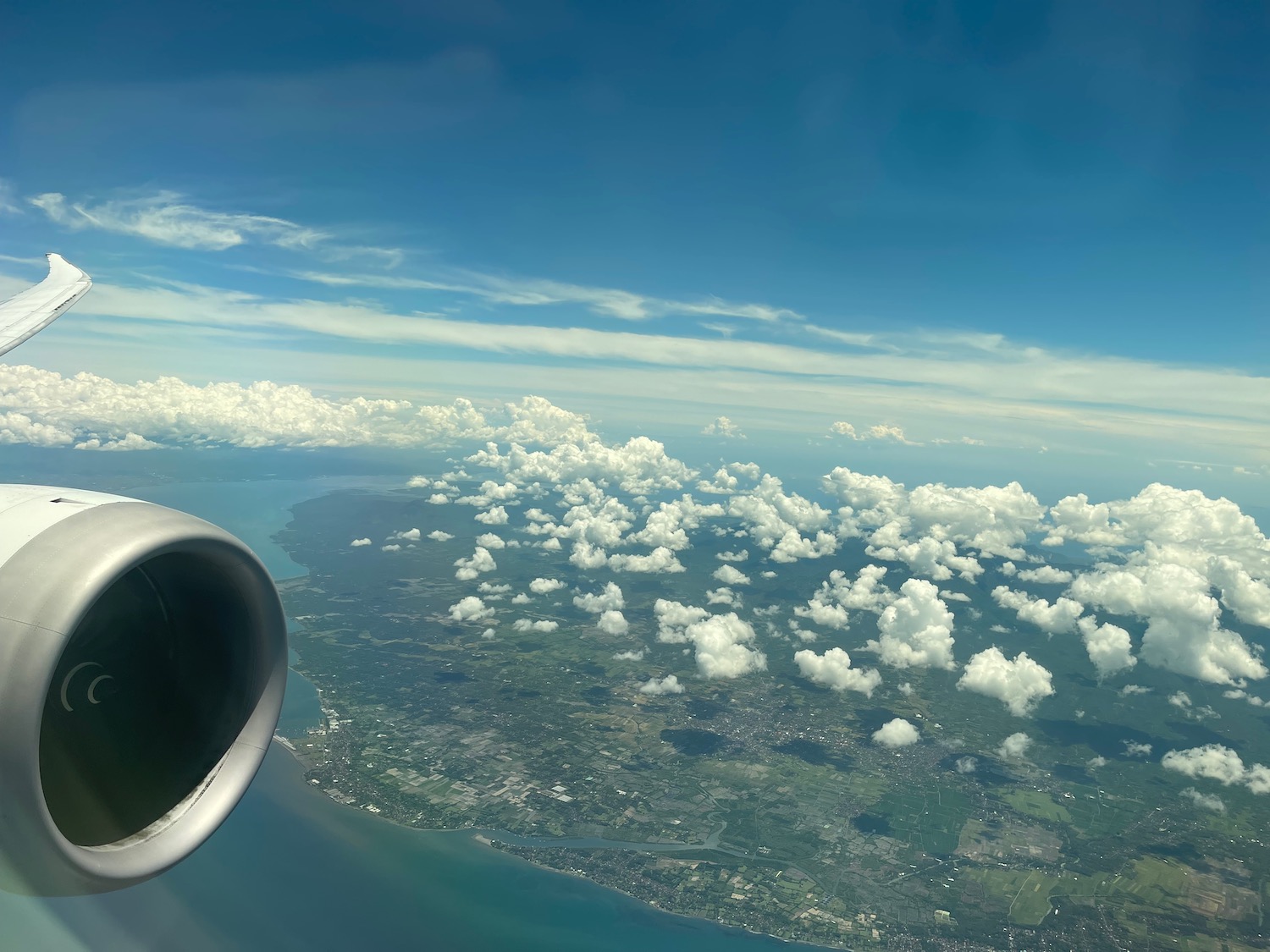 an airplane wing and a body of water