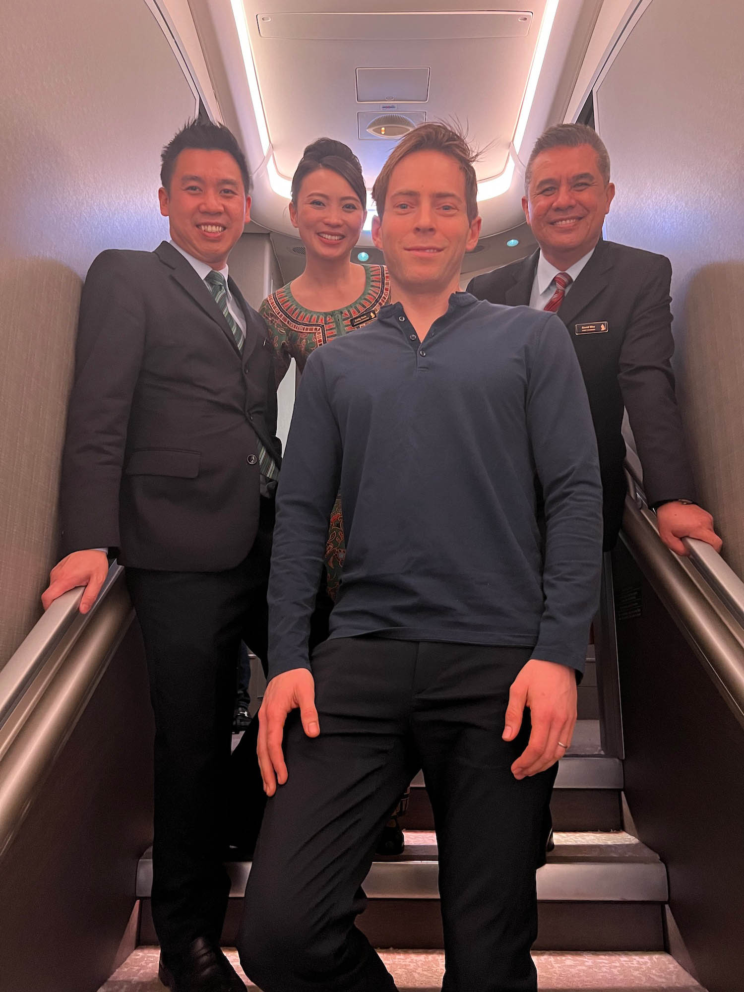 a group of people standing on an airplane stairs