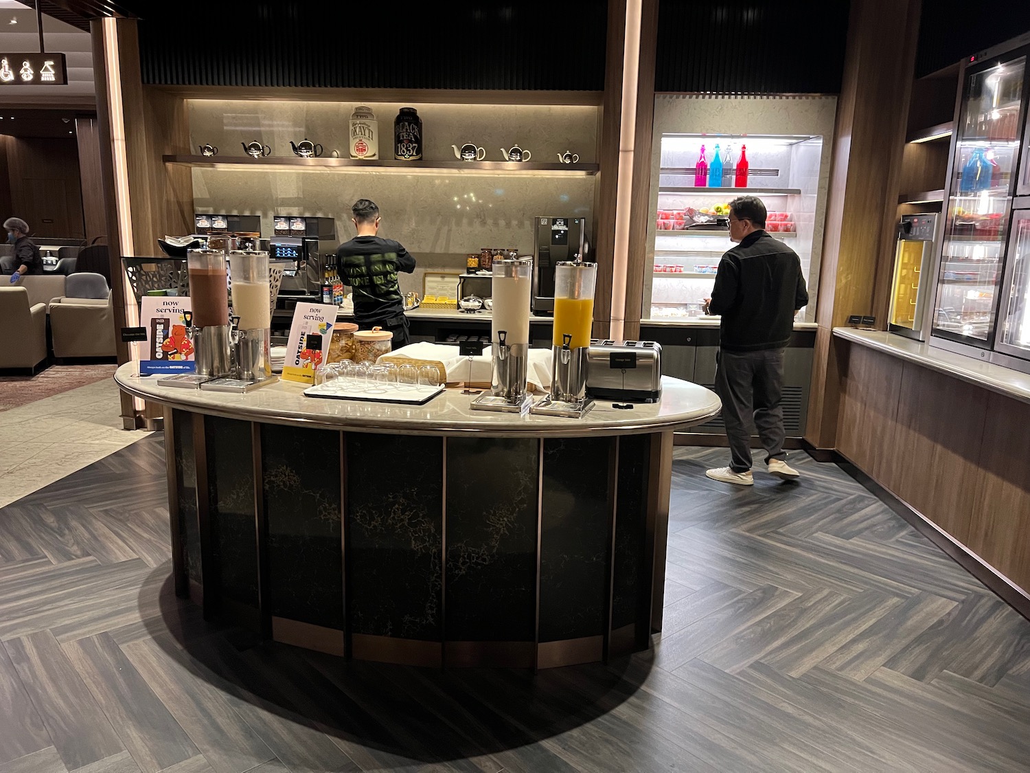 a man standing in front of a counter with drinks