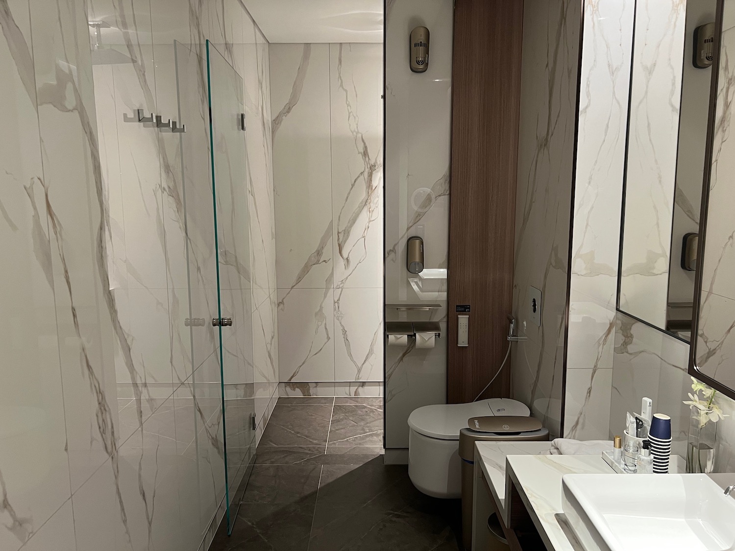 a bathroom with marble walls and a shower