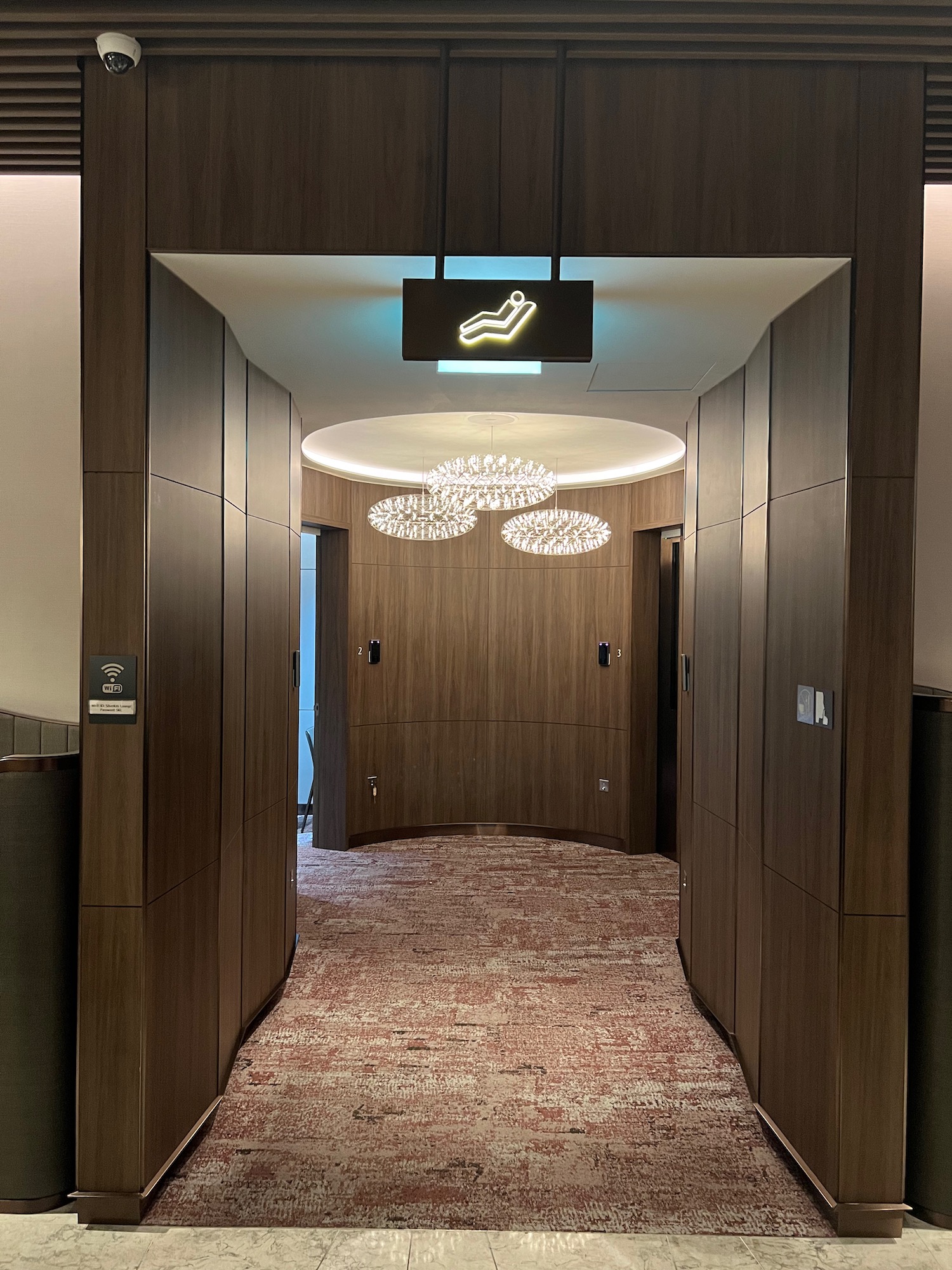 a hallway with a sign and a light fixture