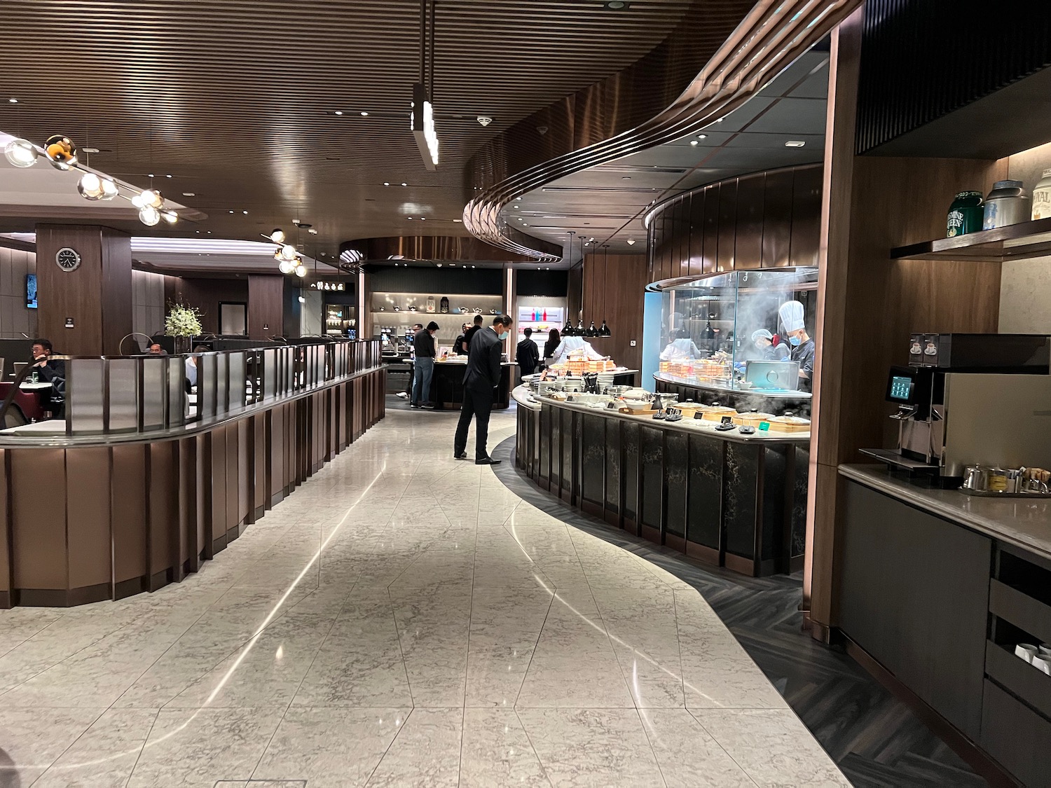 a restaurant with people standing in front of the counter