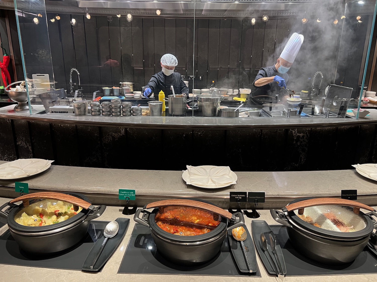 a group of people cooking in a kitchen