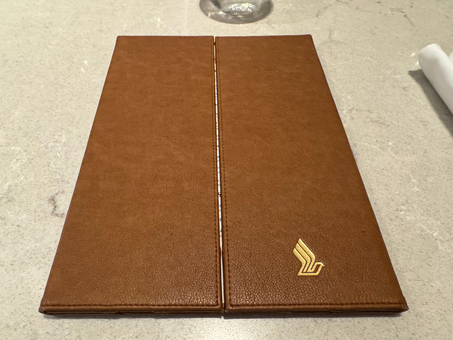 a brown leather menu on a white surface