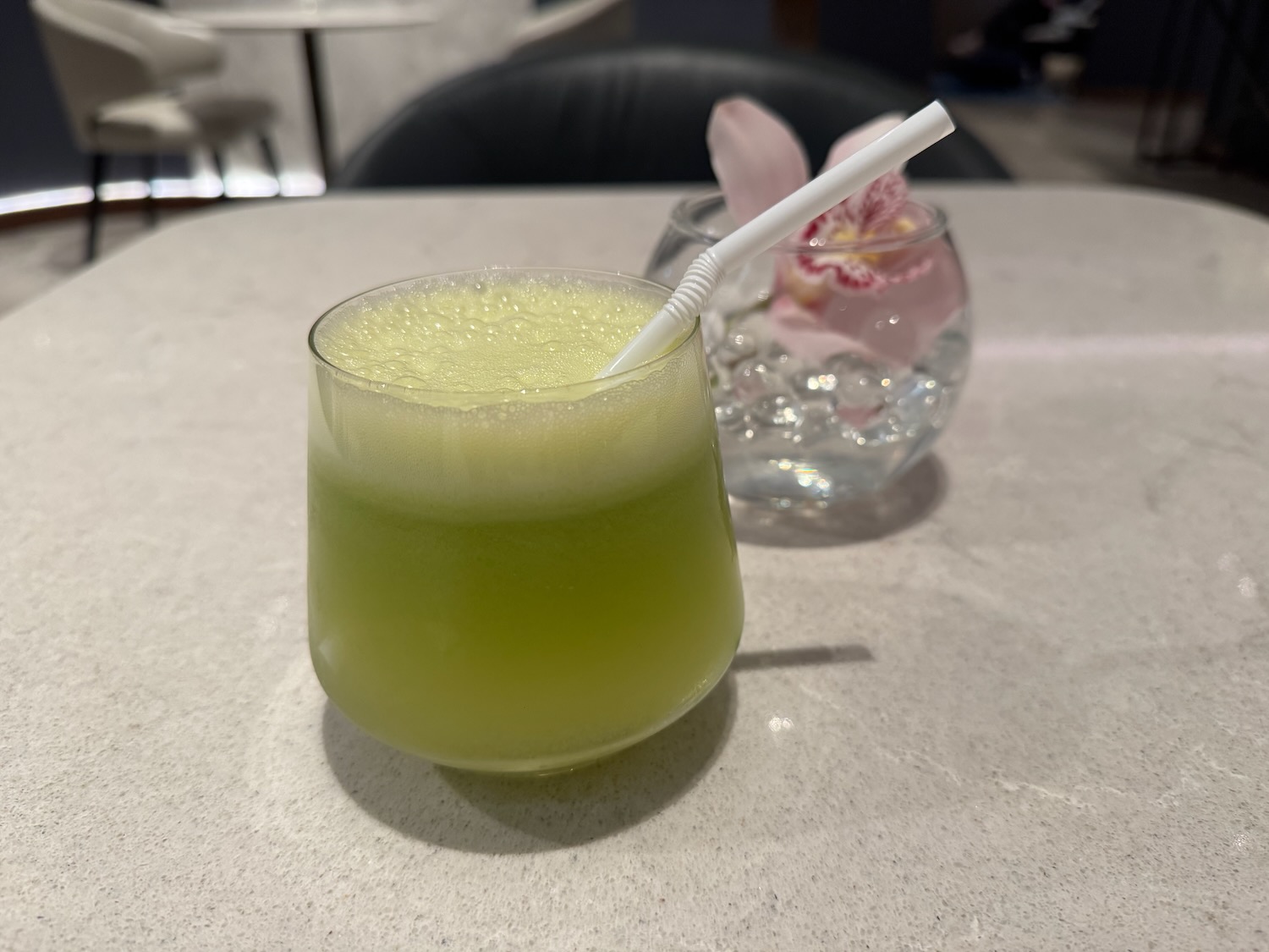 a glass with a straw and a drink in it