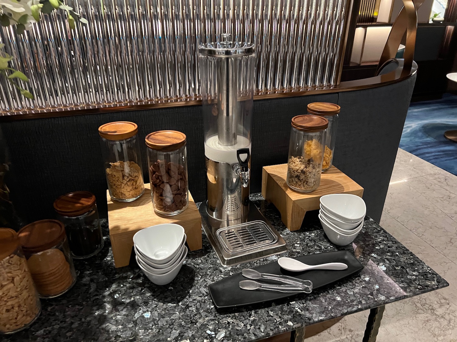 a counter with a machine and bowls and spoons