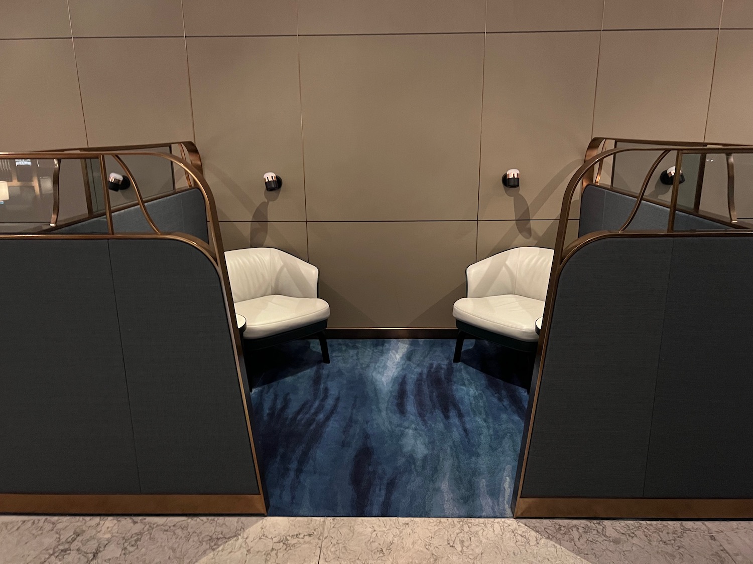 a room with chairs and a blue carpet