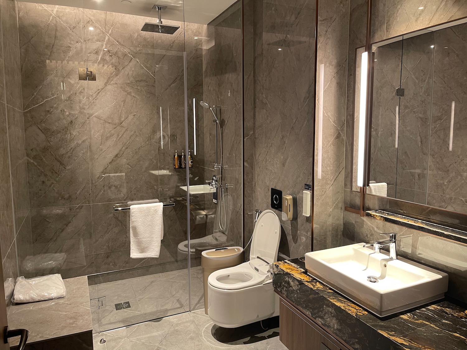 a bathroom with a glass shower and toilet