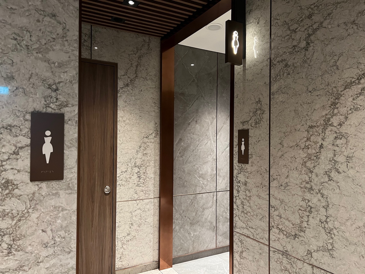 a bathroom with marble walls and a door