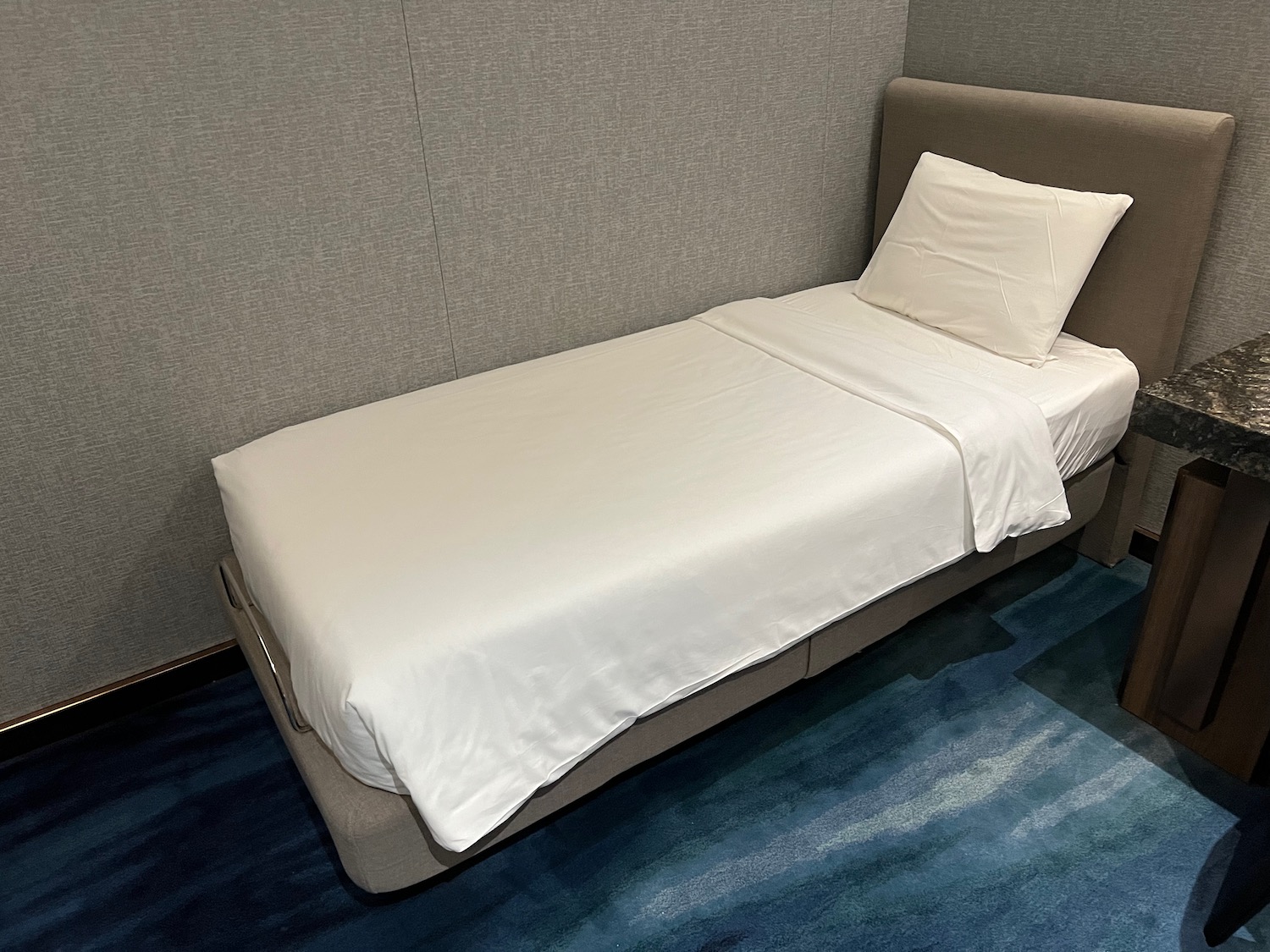 a bed with a white sheet and pillow