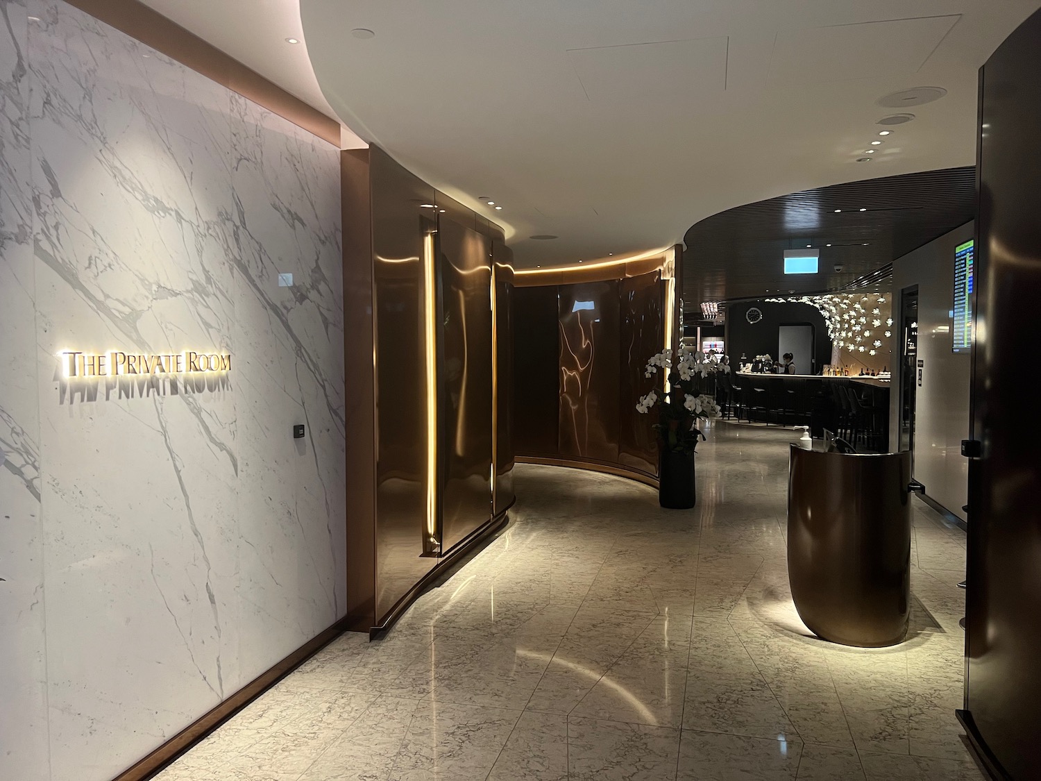 a lobby with marble walls and a reception desk