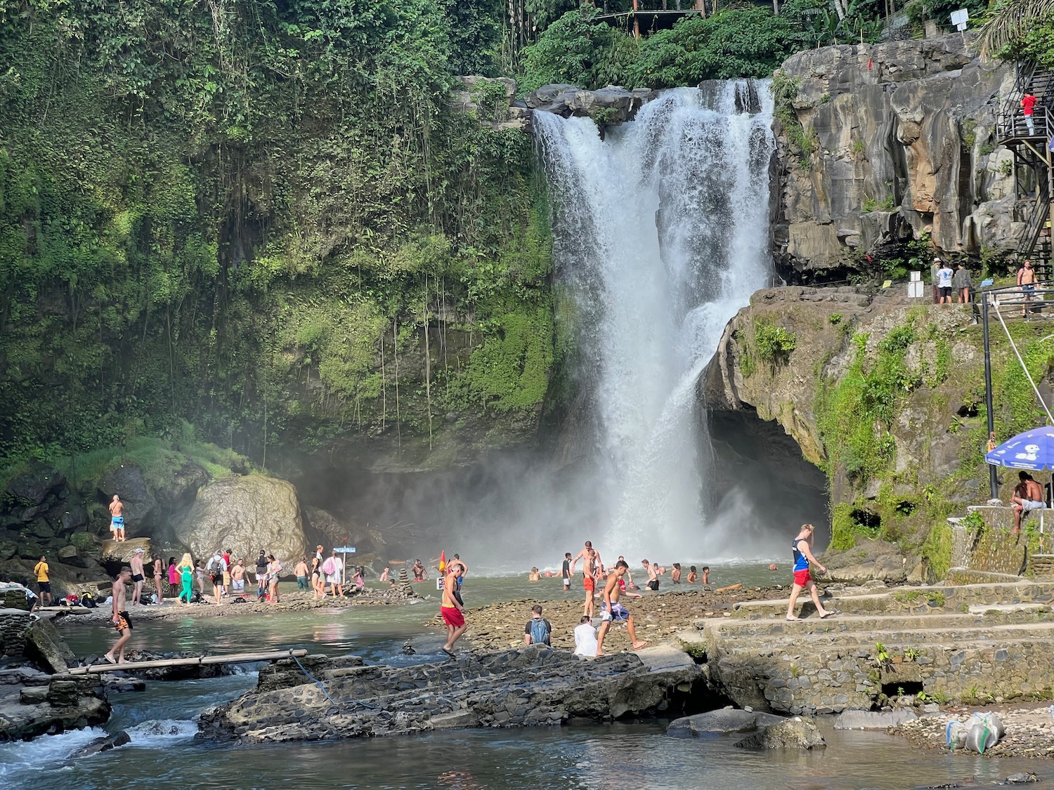 a group of people by a waterfall