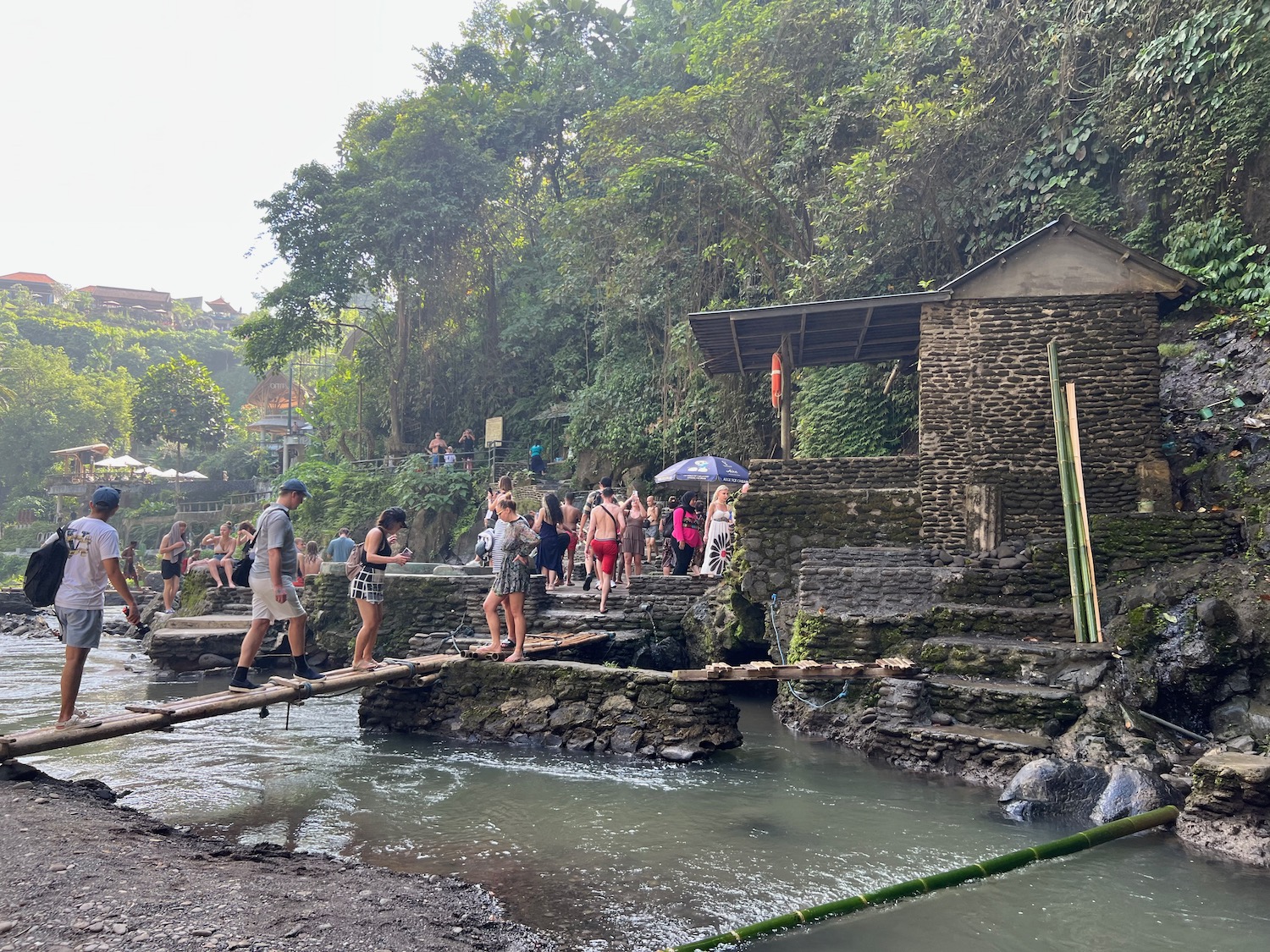 a group of people crossing a river