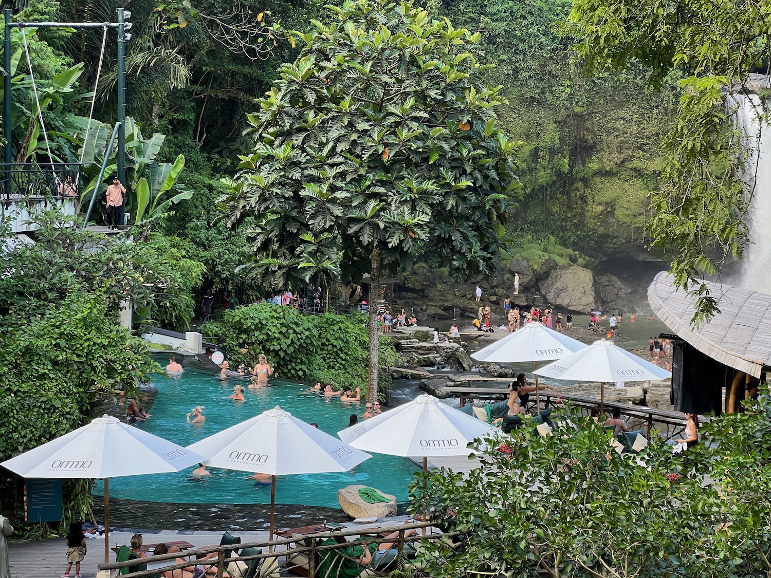 a pool with umbrellas and people in it