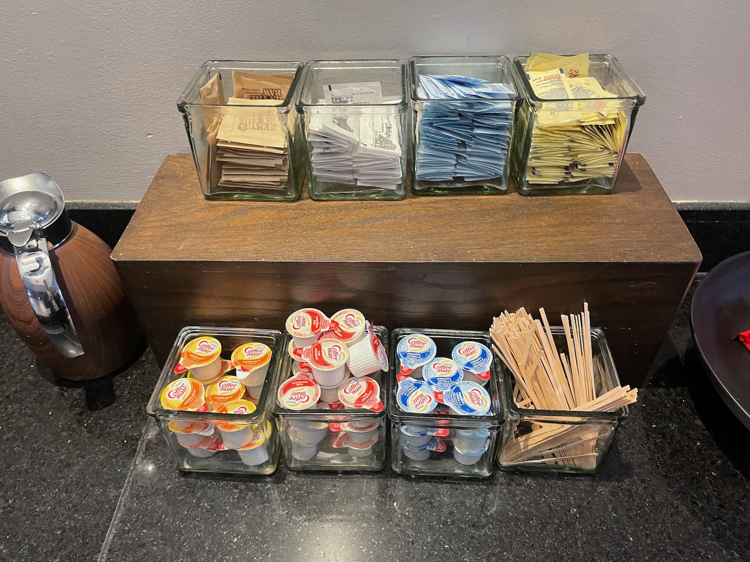 a group of glass containers with different types of condiments