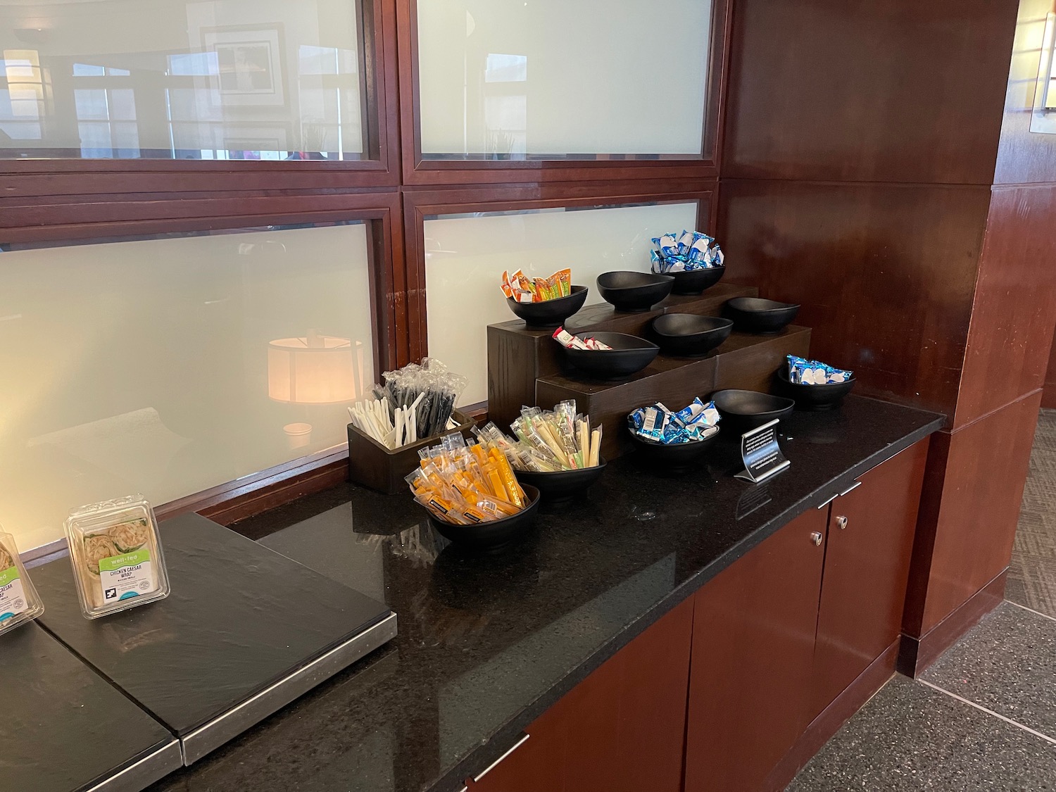 a counter with bowls of candy and straws