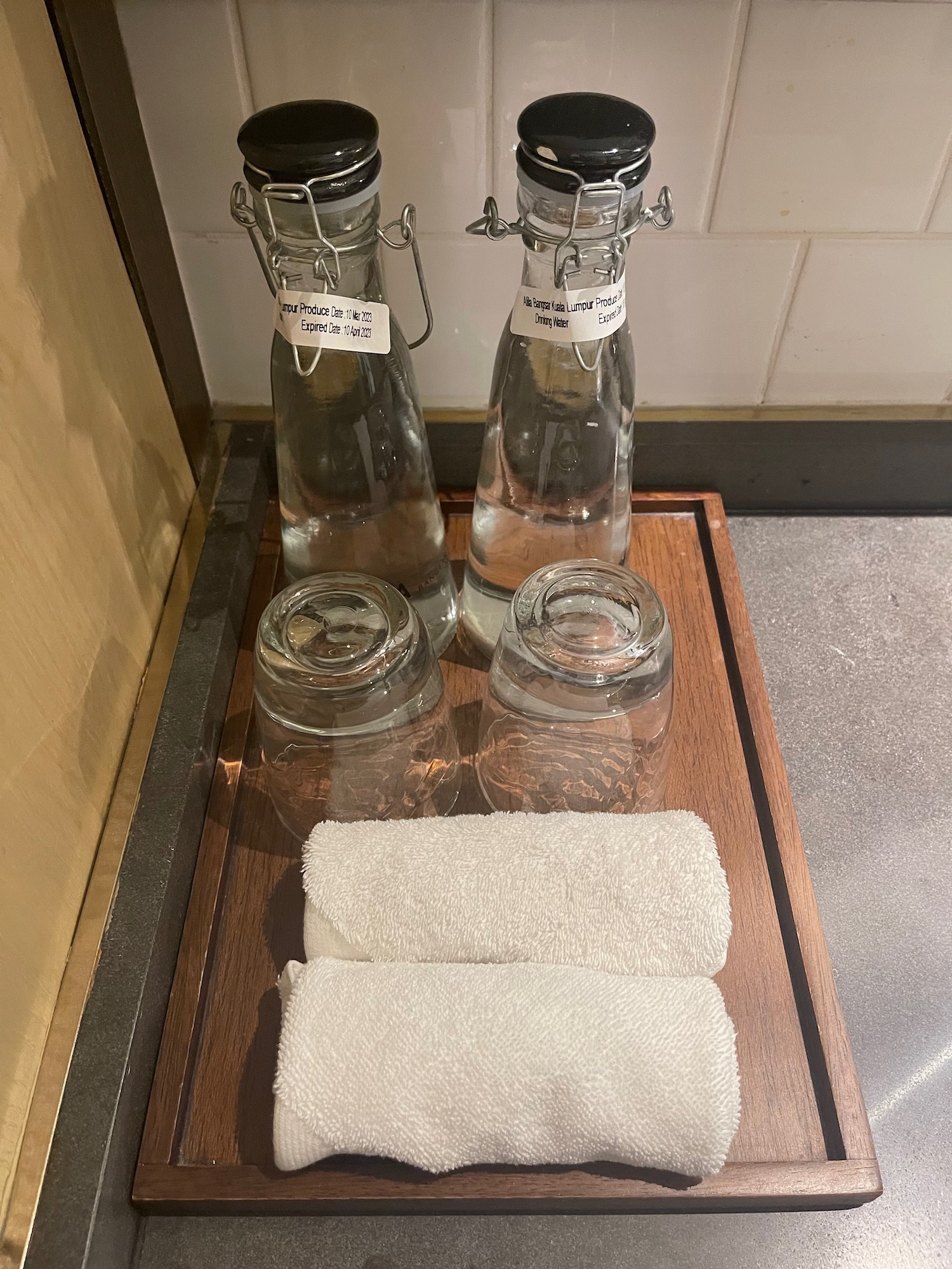 a group of glass bottles and towels on a tray