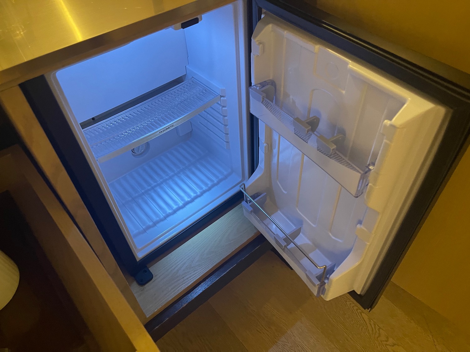 a small refrigerator with a light in it
