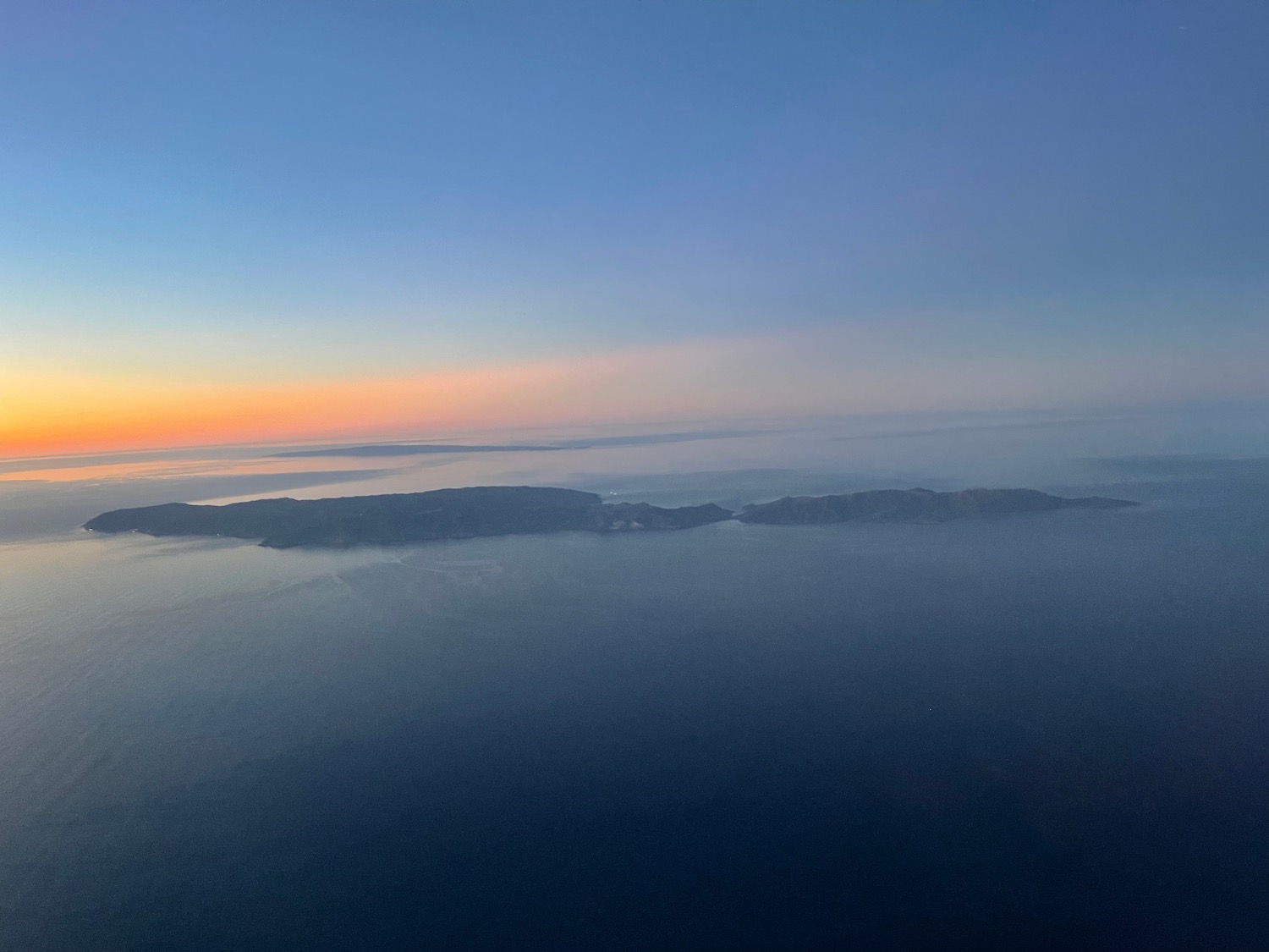 an aerial view of land and water