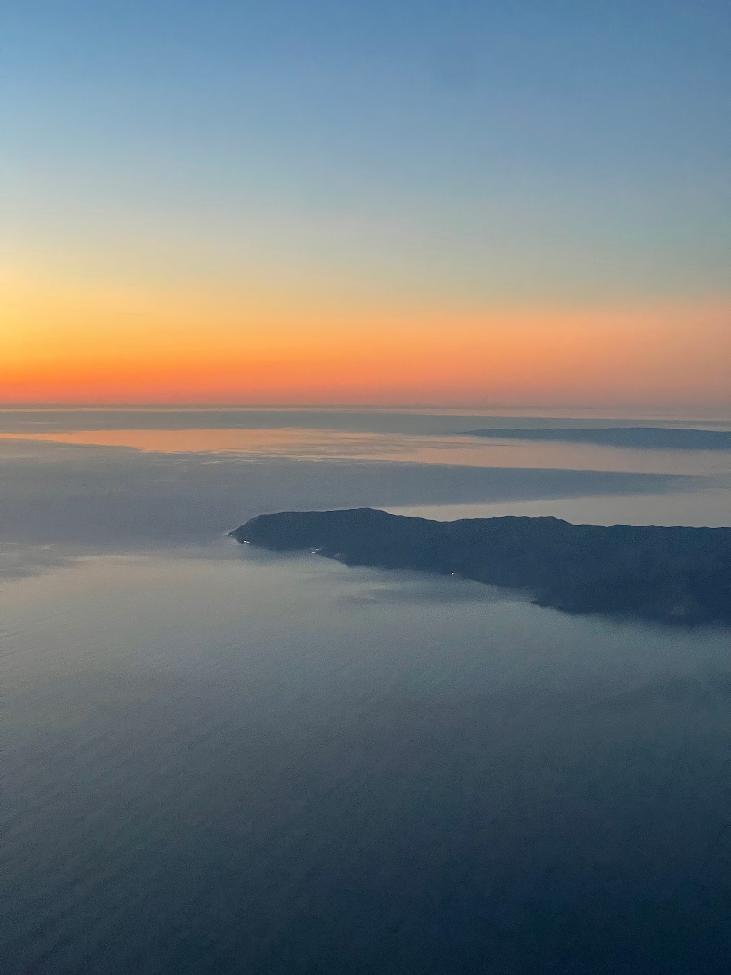 an aerial view of land and water