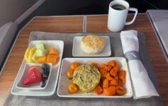 a plate of food and a cup of coffee on a table