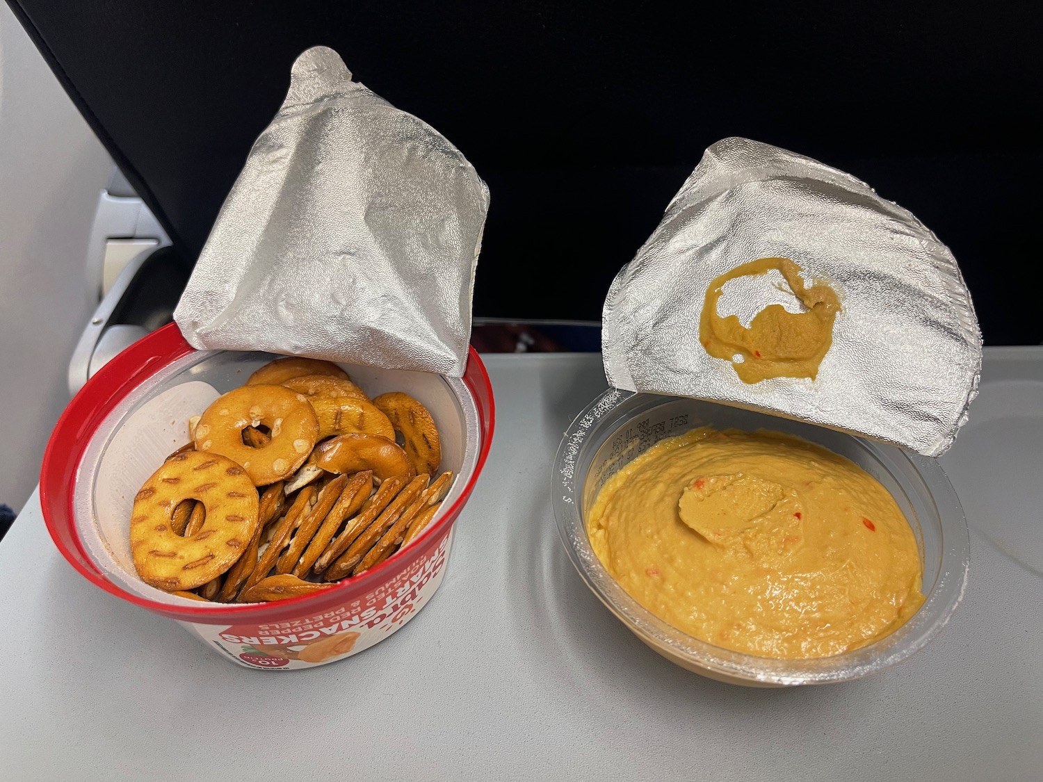 two bowls of dips and pretzels