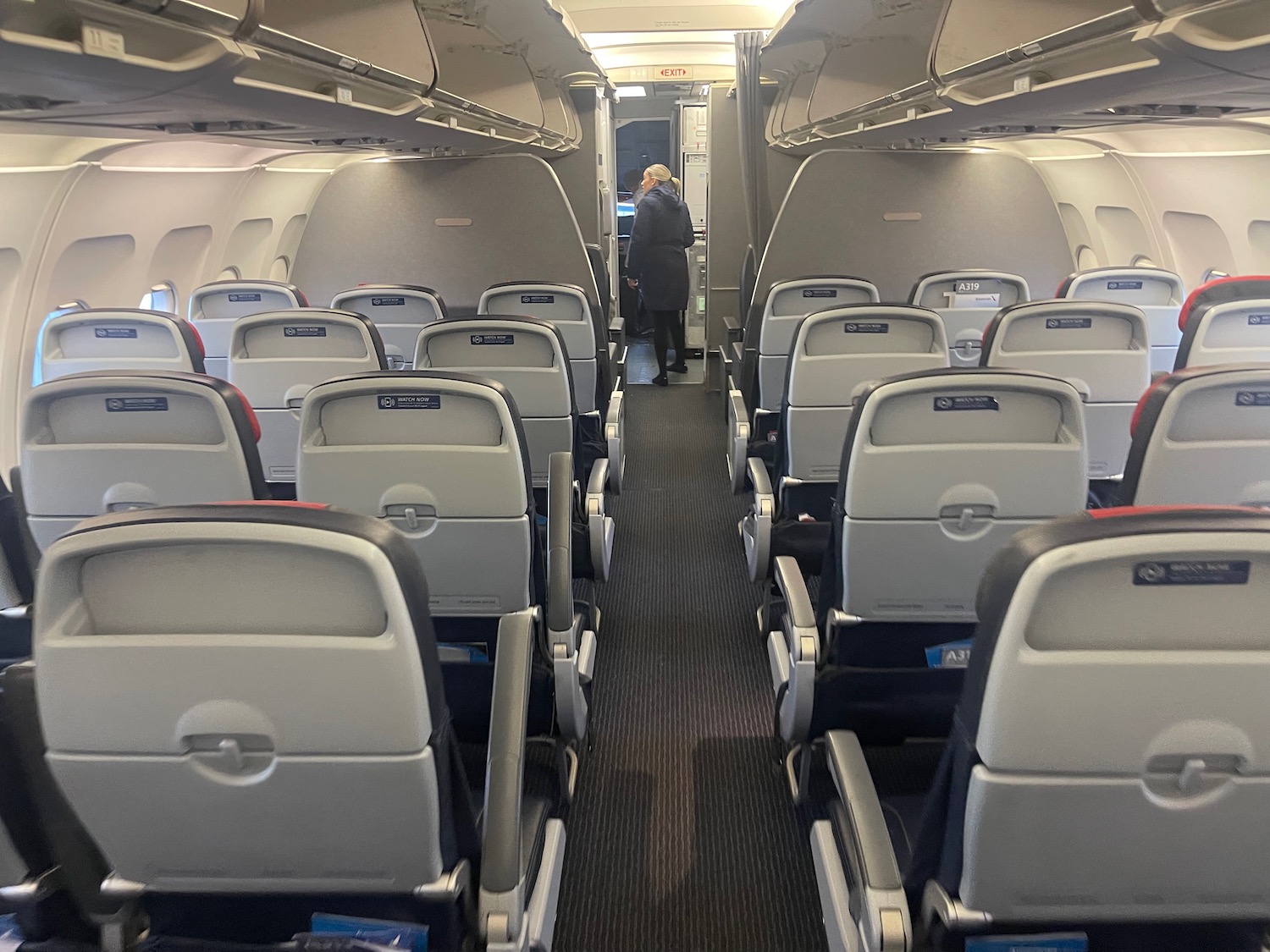 an airplane with seats and a person standing in the back
