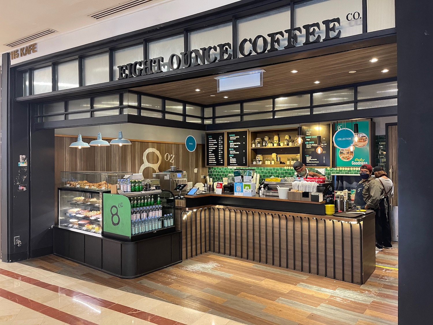 a coffee shop with a counter and a man standing behind it