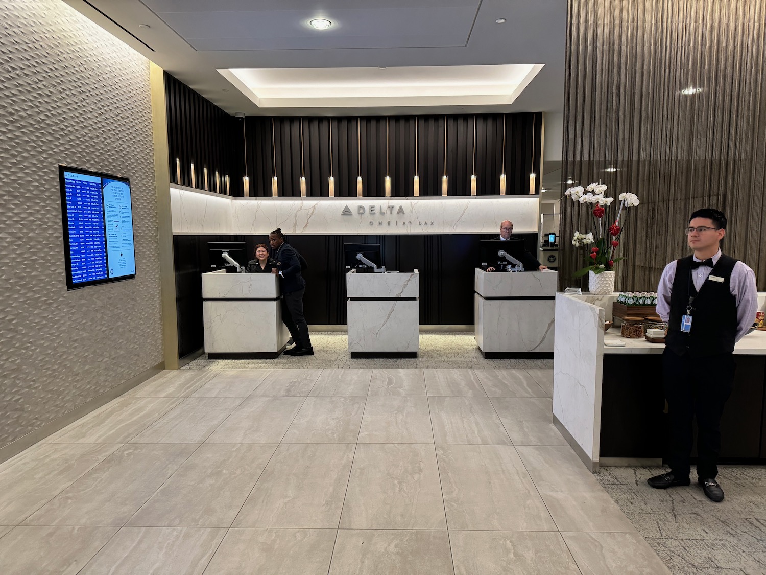 a group of people standing at a reception desk