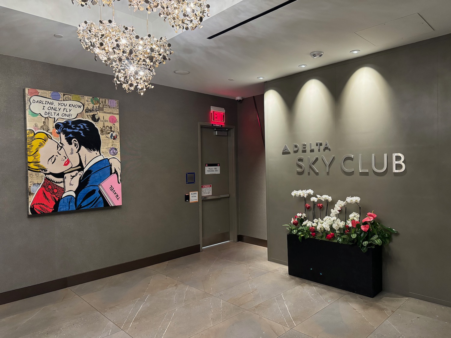 a lobby with a sign and flowers