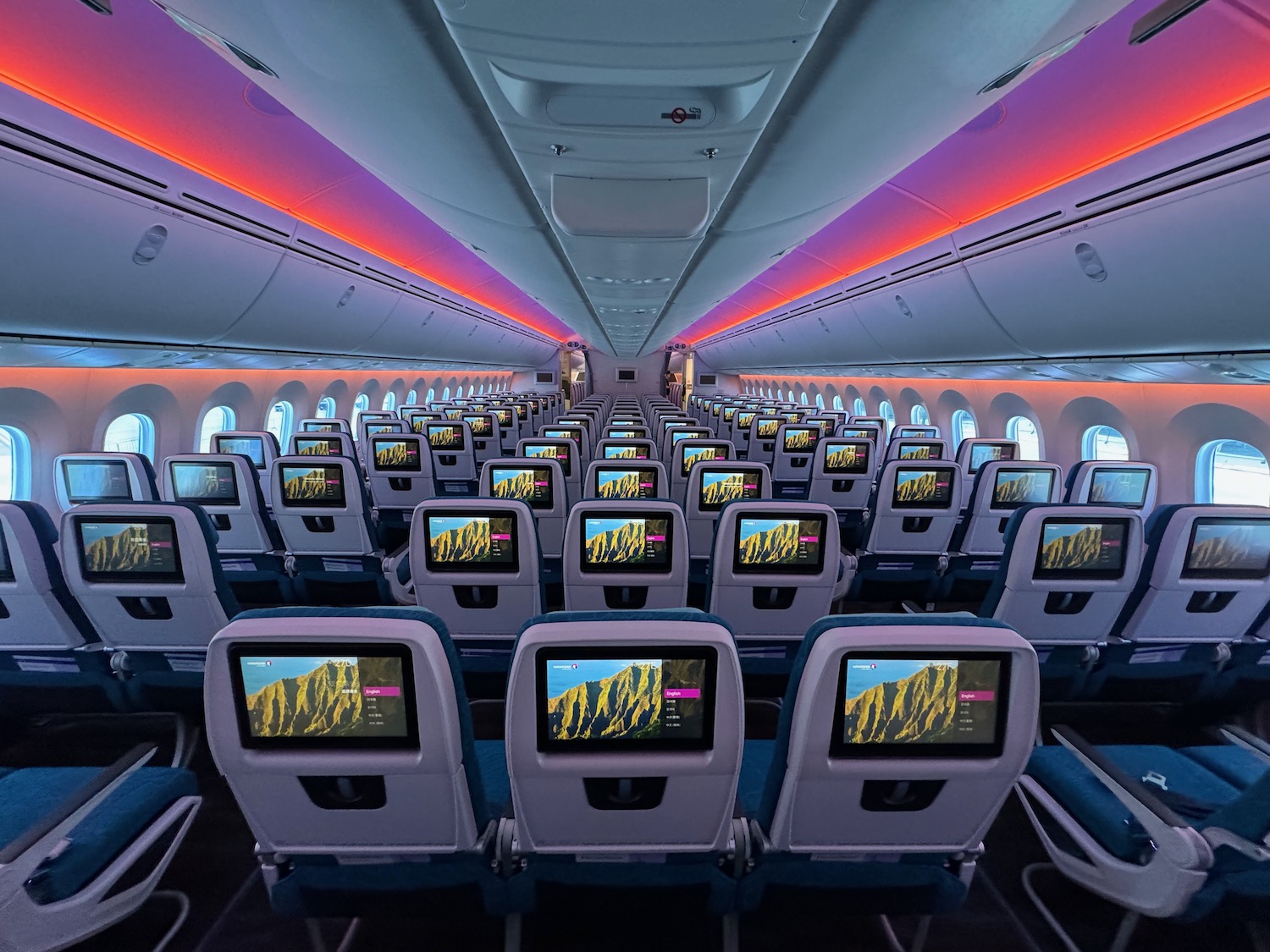 an airplane with rows of seats and monitors