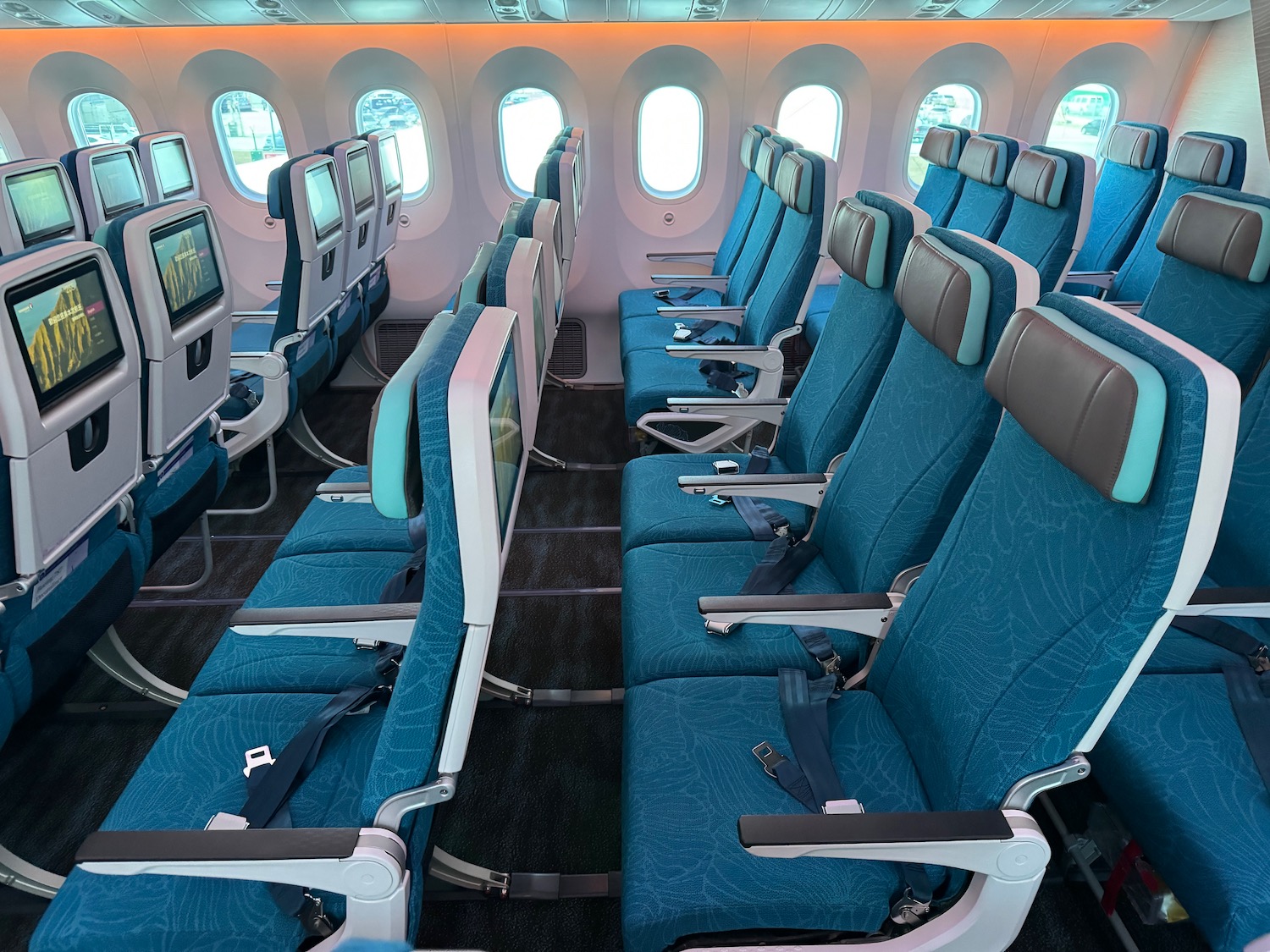 a row of blue seats in an airplane