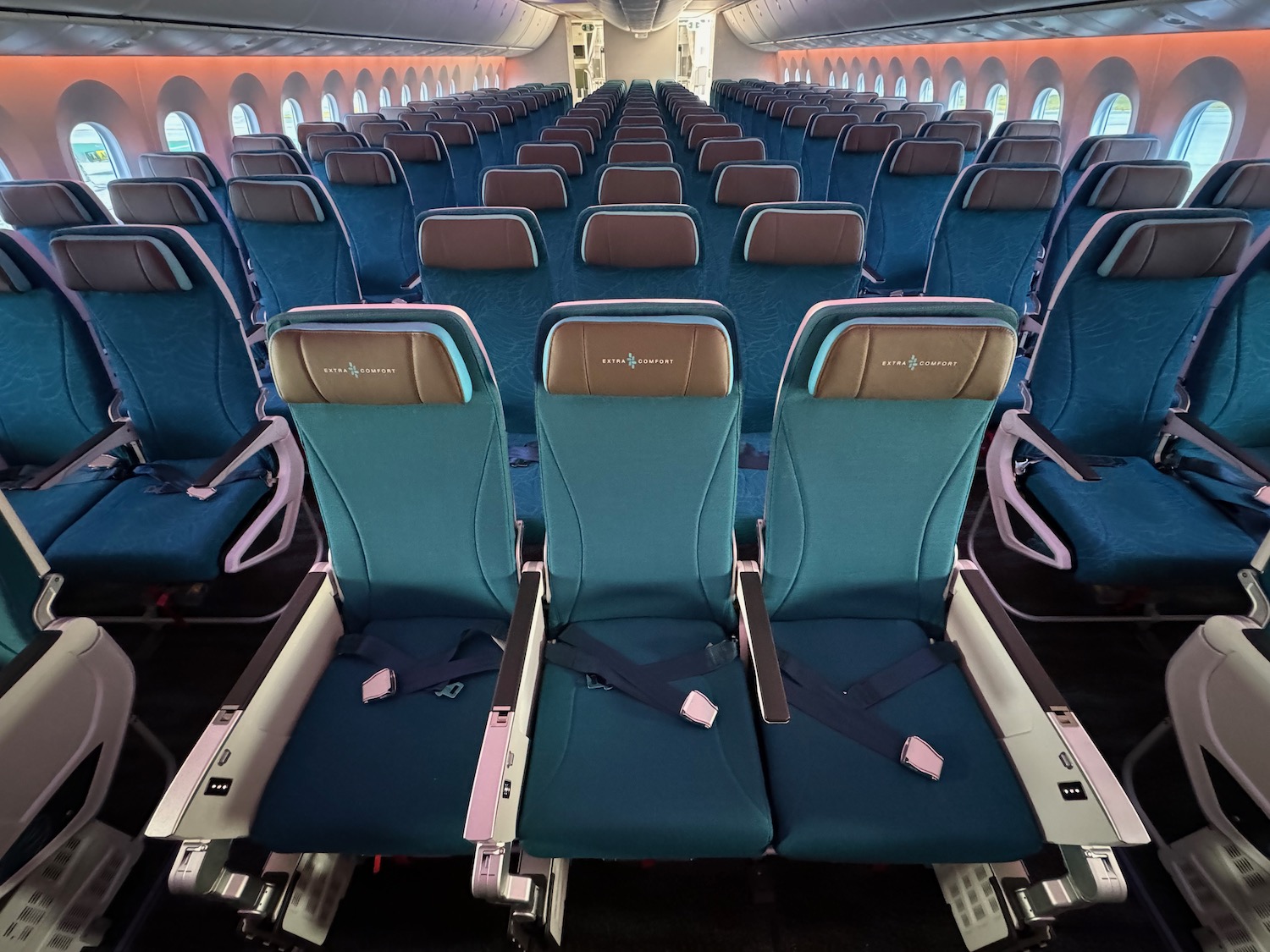 a row of blue seats in an airplane