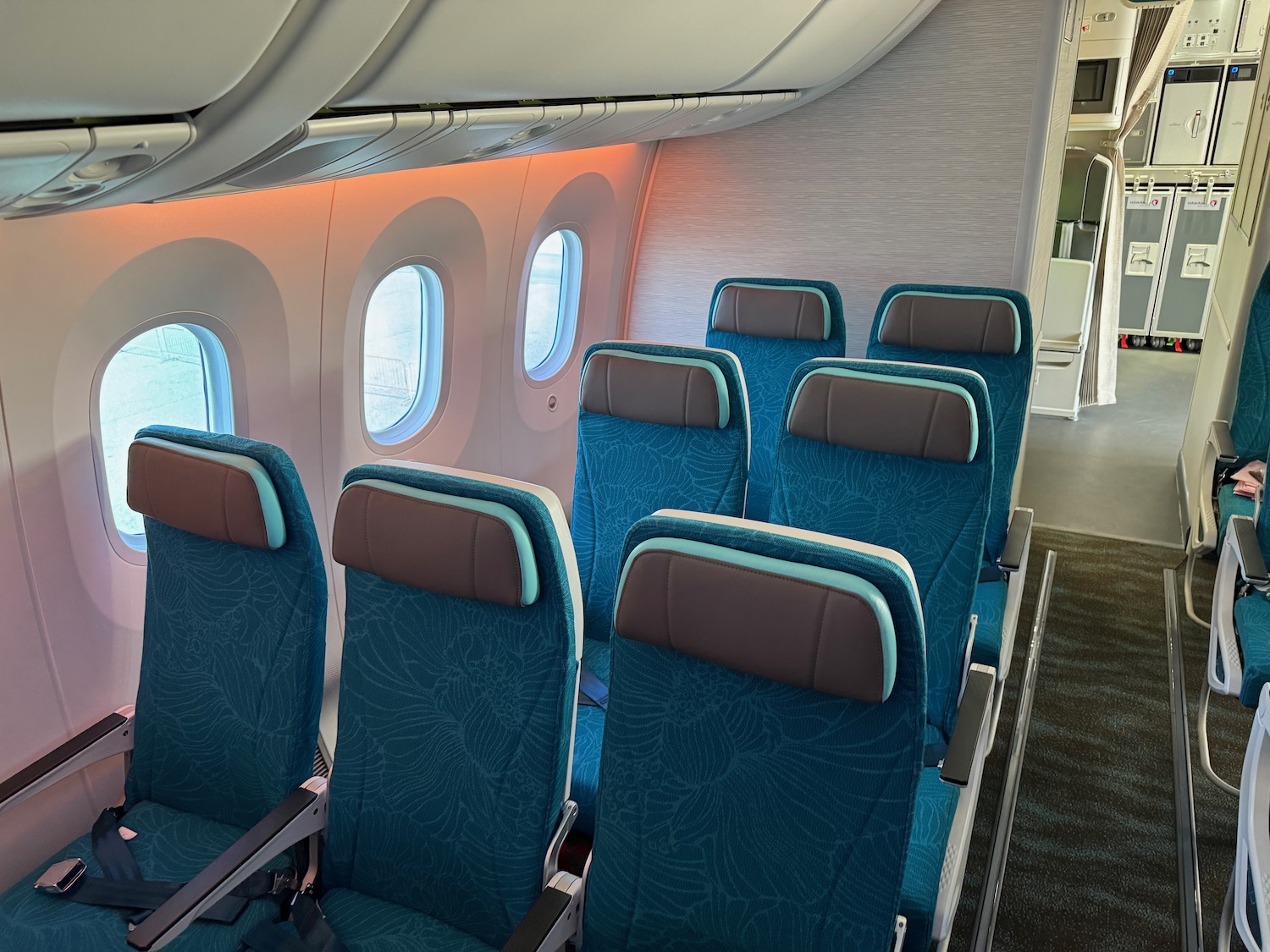 a row of blue seats in an airplane