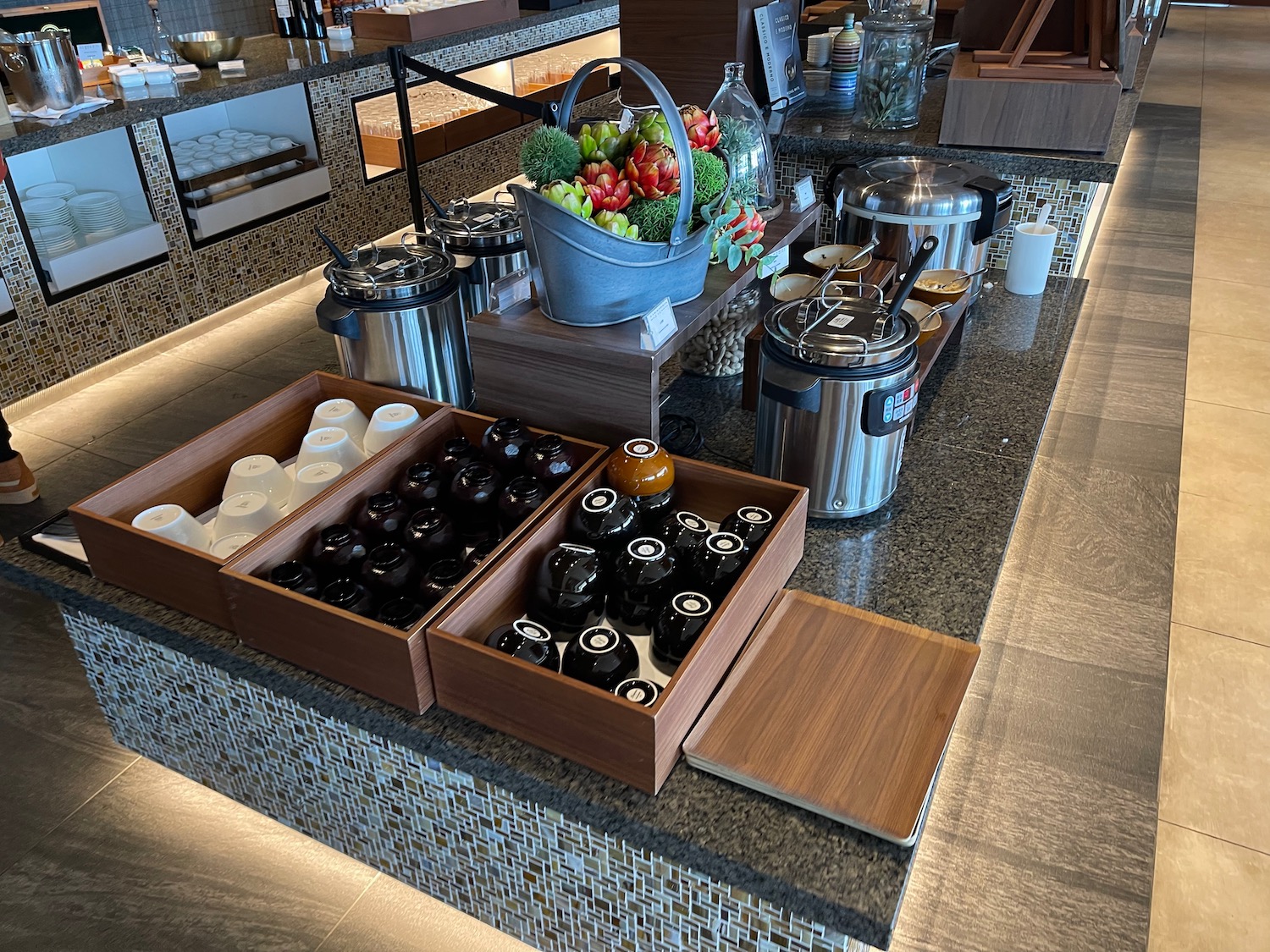 a buffet table with different containers of food