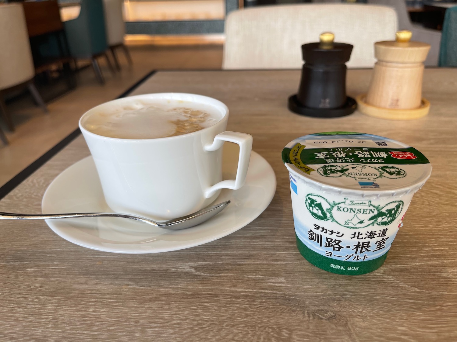 a cup of coffee and yogurt on a table