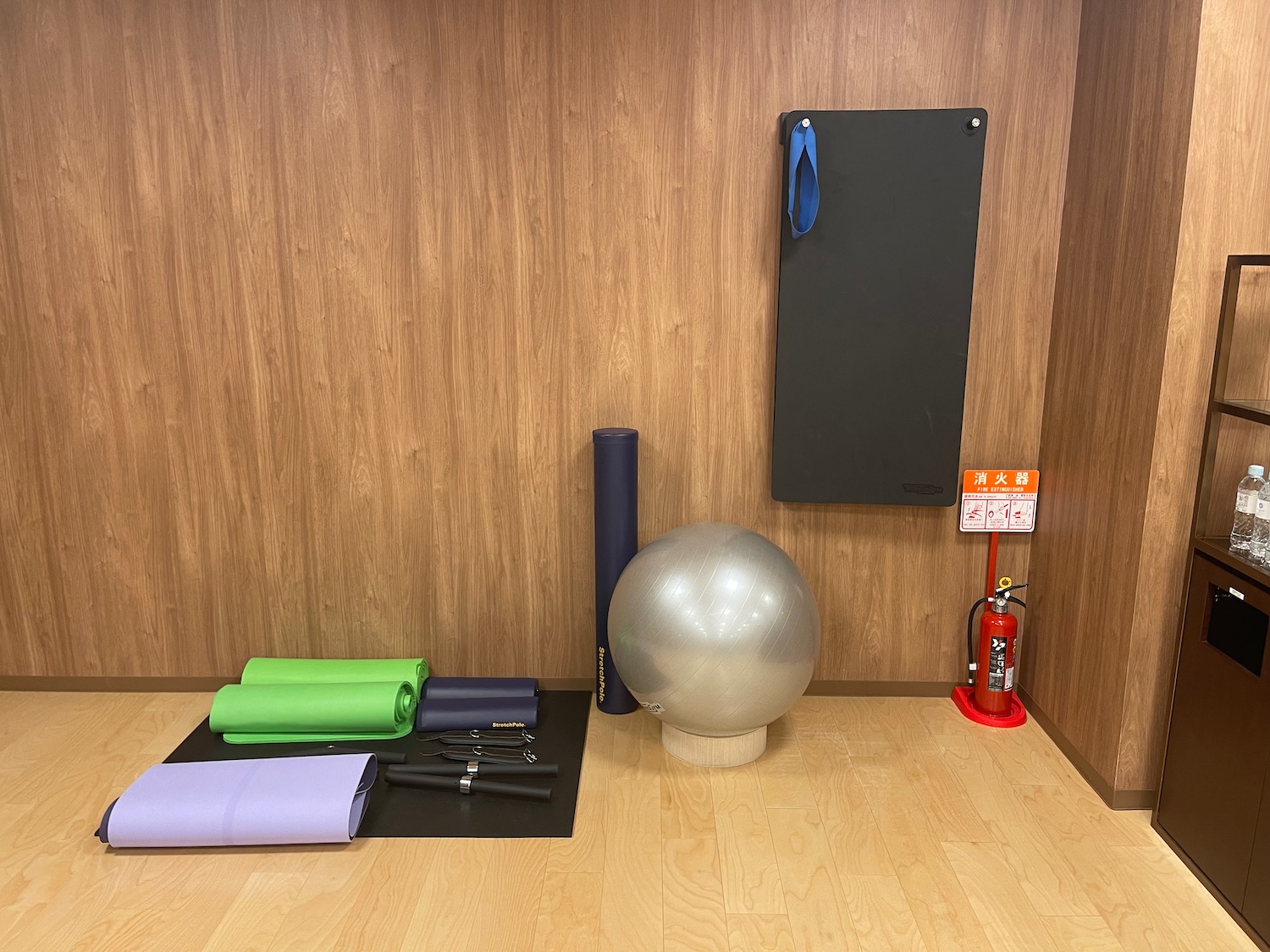 a yoga mat and exercise equipment on a wood floor