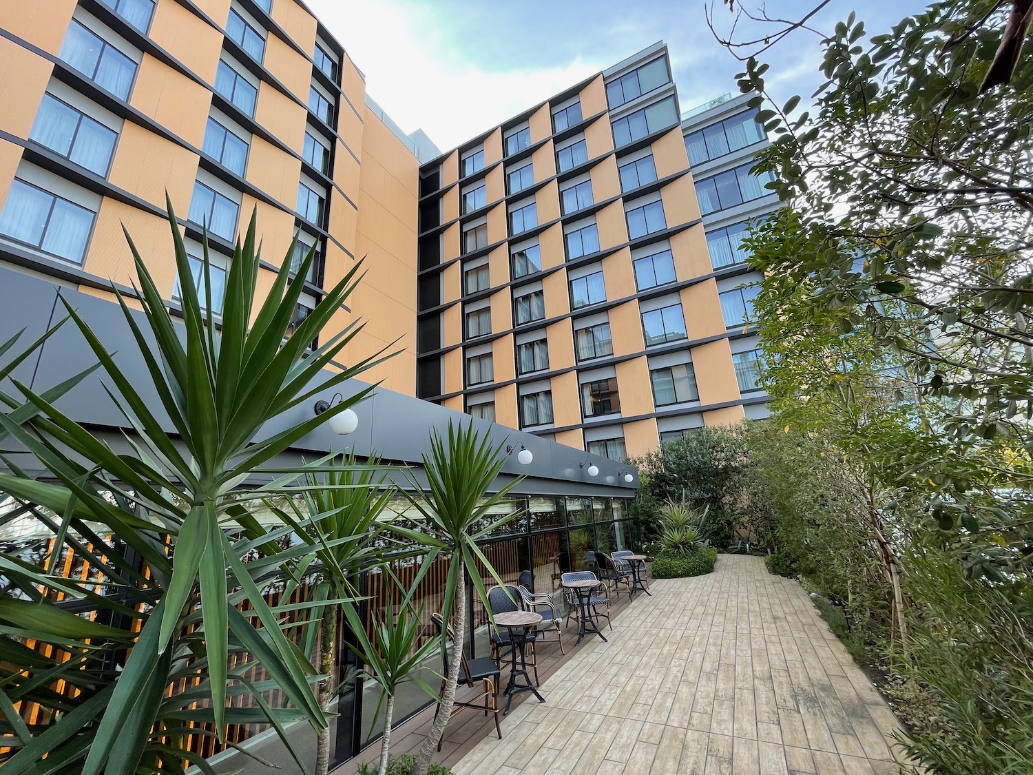 a building with a wood walkway and chairs