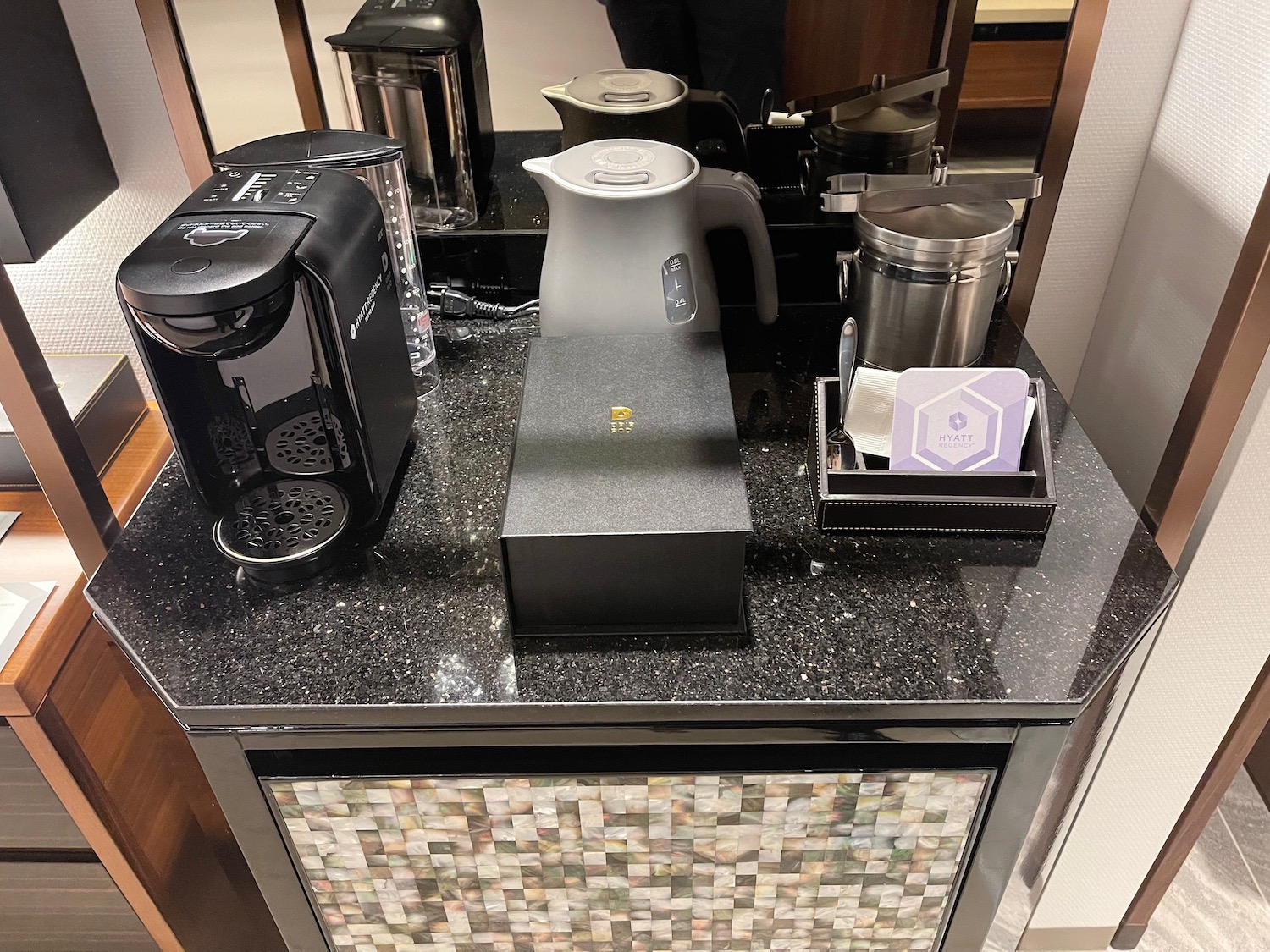 a coffee maker and coffee maker on a counter