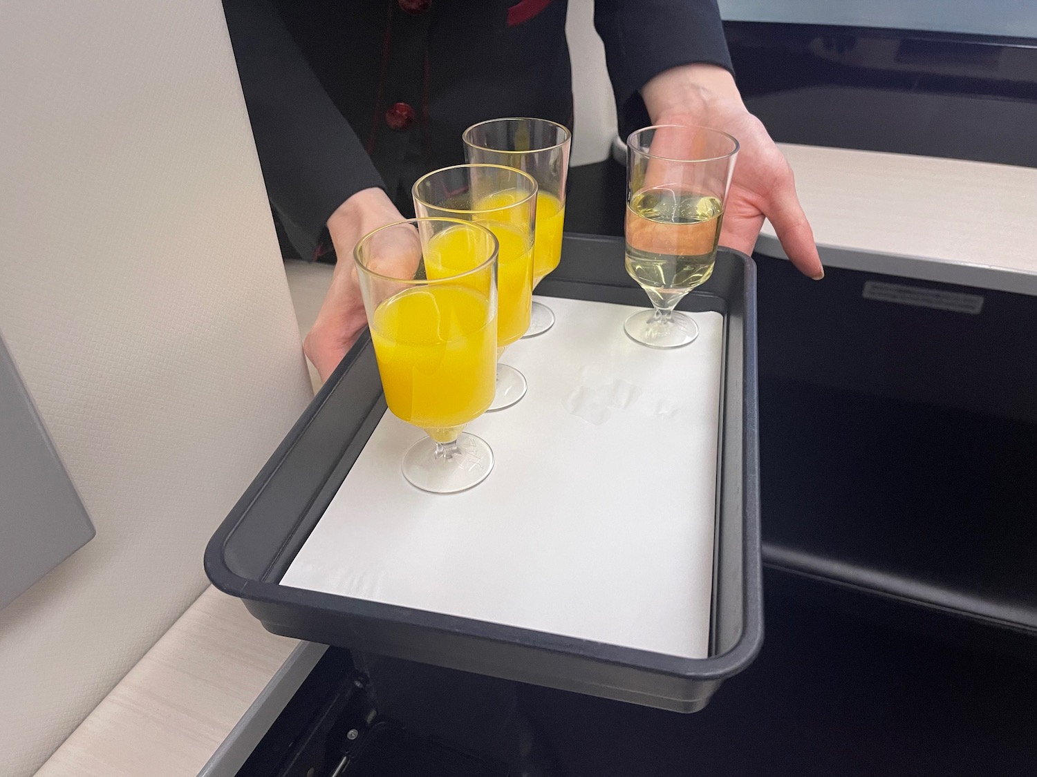 a tray of glasses with yellow liquid